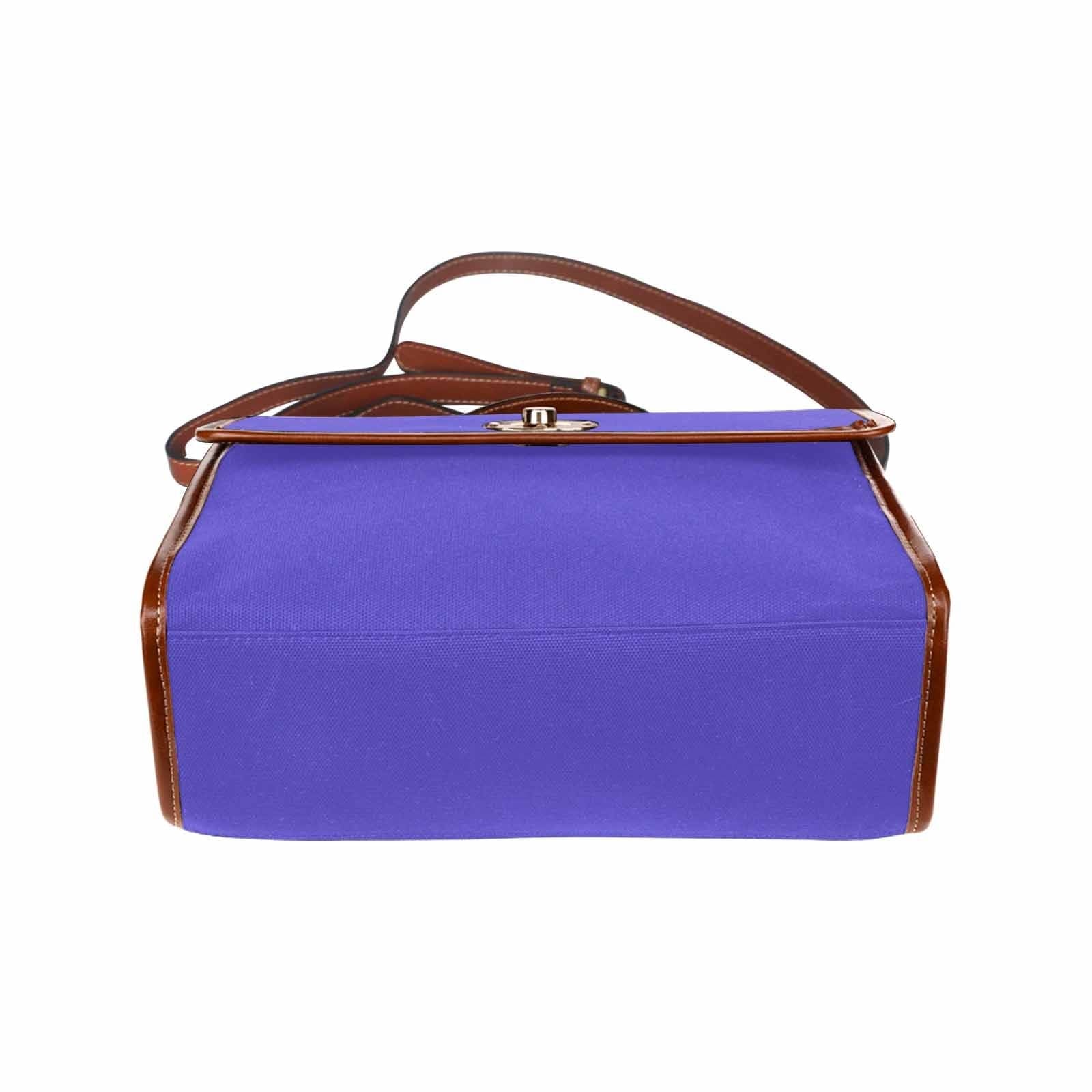 Blue Iris Waterproof Canvas Handbag with brown crossbody strap, showcasing its stylish design and durable material.