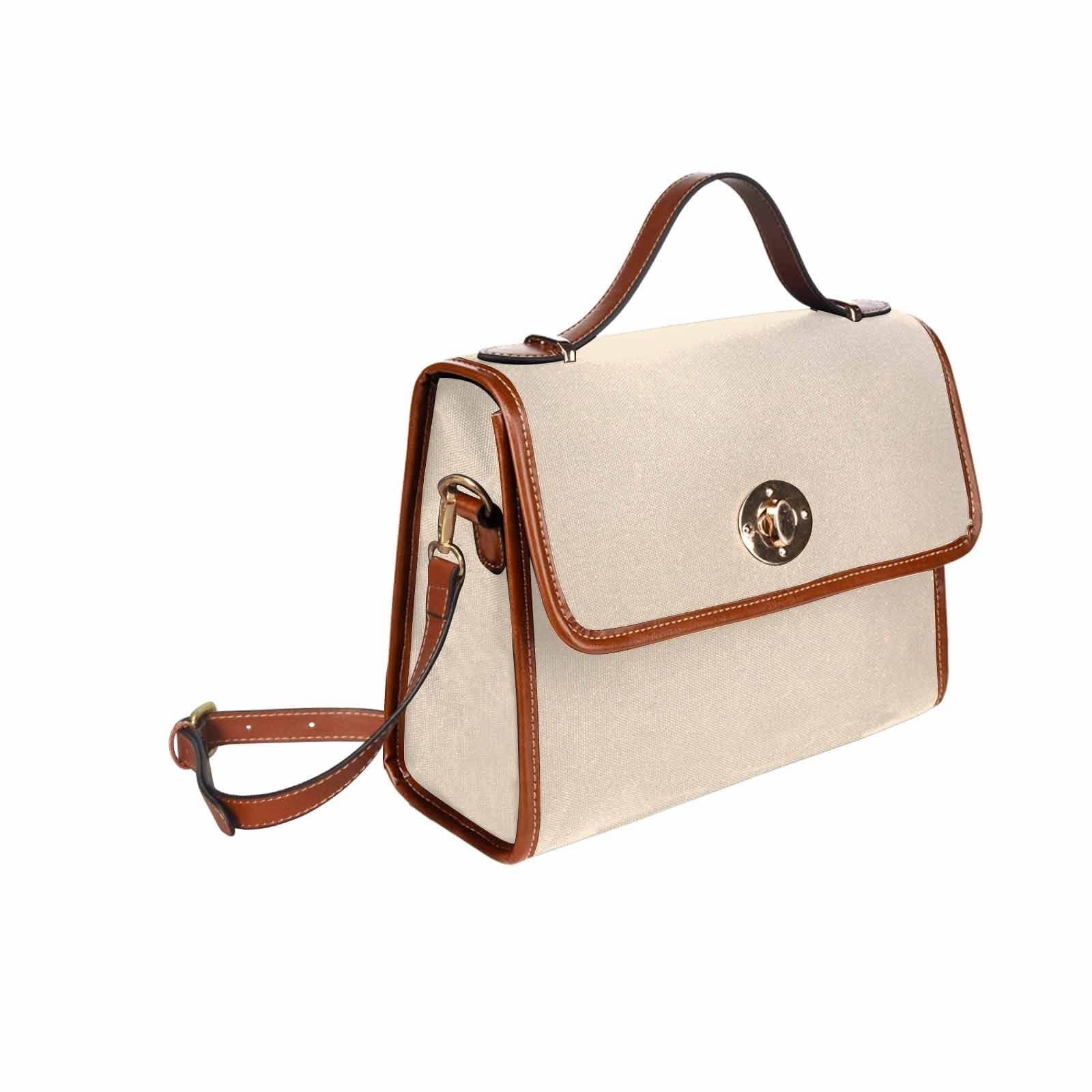 Stylish champagne beige canvas handbag with brown crossbody strap, featuring two interior pockets and a zipper pocket.