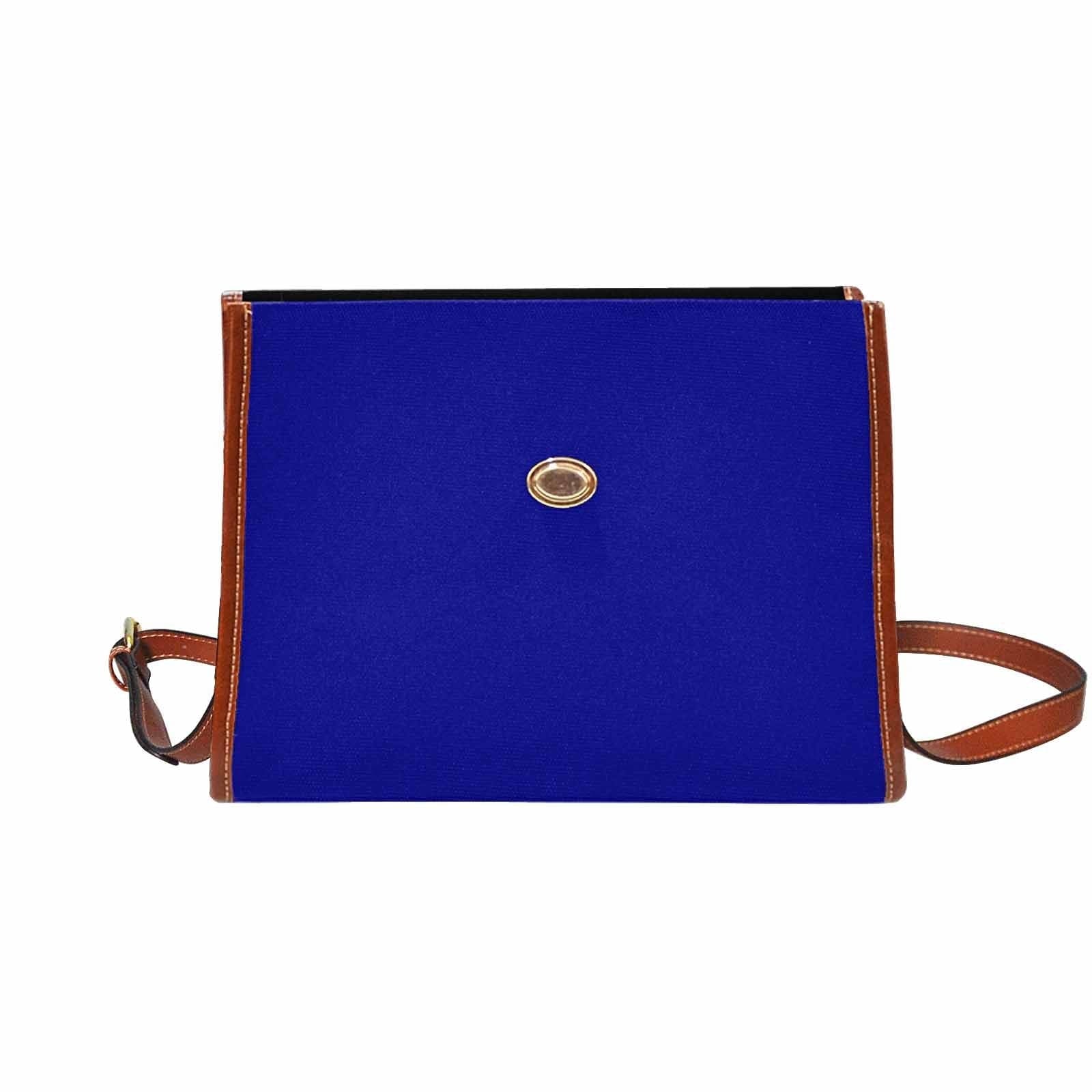 Dark blue waterproof canvas handbag with brown crossbody strap, featuring two interior pockets and a zipper pocket.