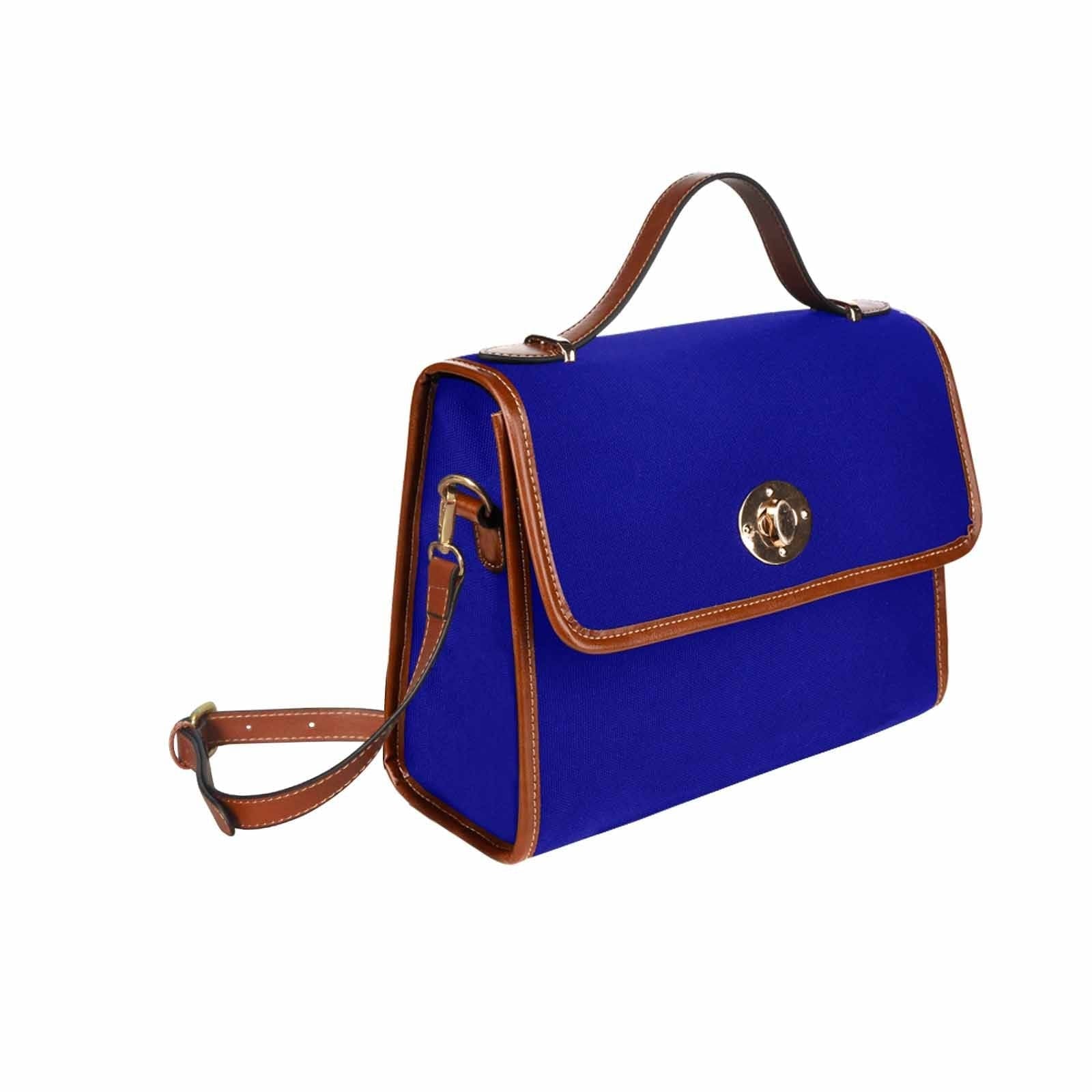 Dark blue waterproof canvas handbag with brown crossbody strap, featuring two interior pockets and a zipper pocket.