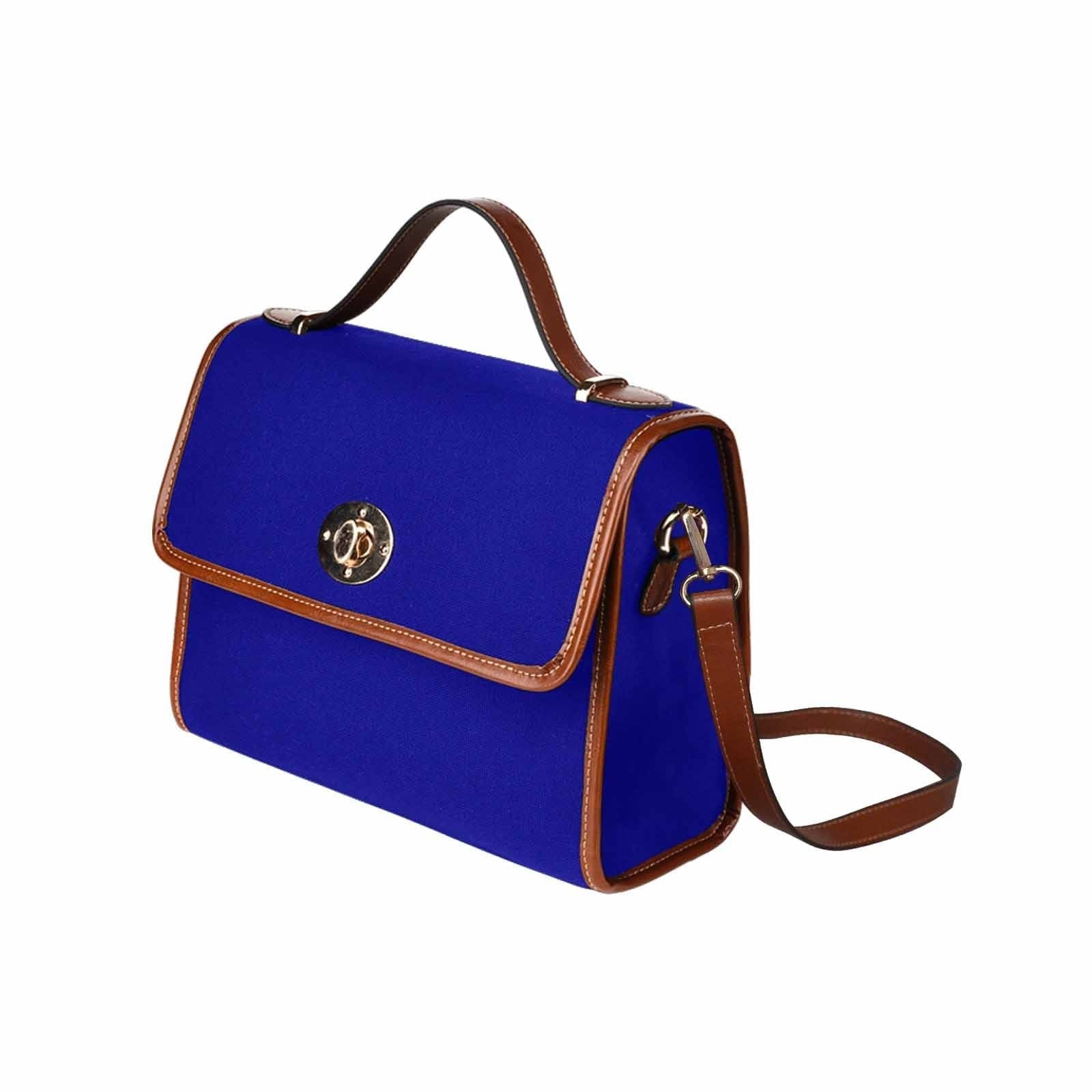 Dark blue waterproof canvas handbag with brown crossbody strap, featuring two interior pockets and a zipper pocket.