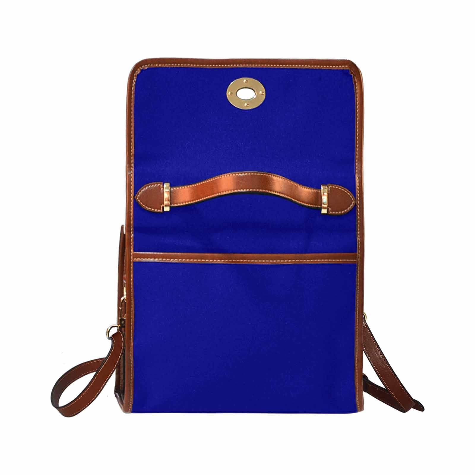 Dark blue waterproof canvas handbag with brown crossbody strap, featuring two interior pockets and a zipper pocket.