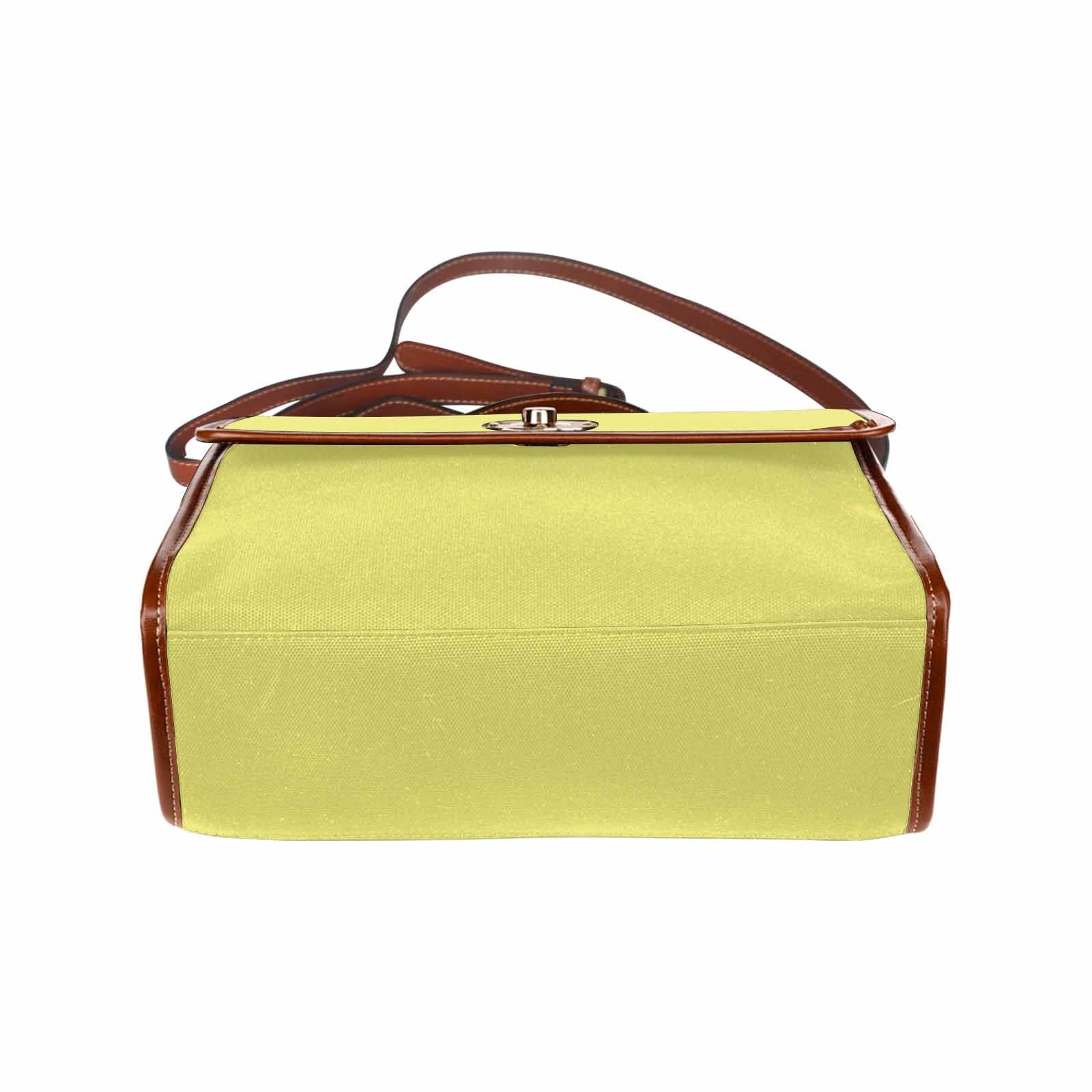 Stylish honeysuckle yellow canvas handbag with brown crossbody strap, featuring two interior pockets and a zipper pocket.