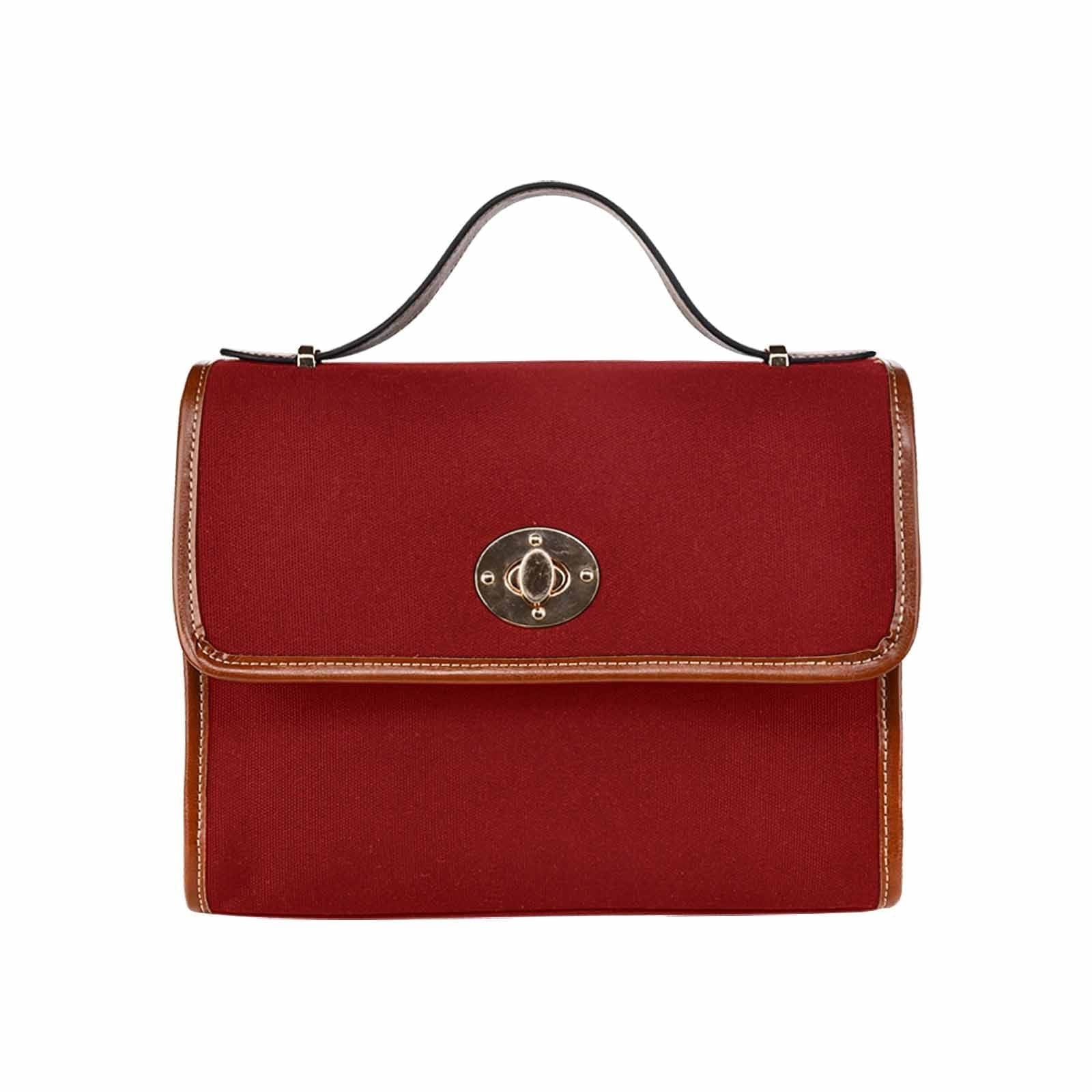 Maroon red waterproof canvas handbag with brown crossbody strap, showcasing its stylish design and functional features.