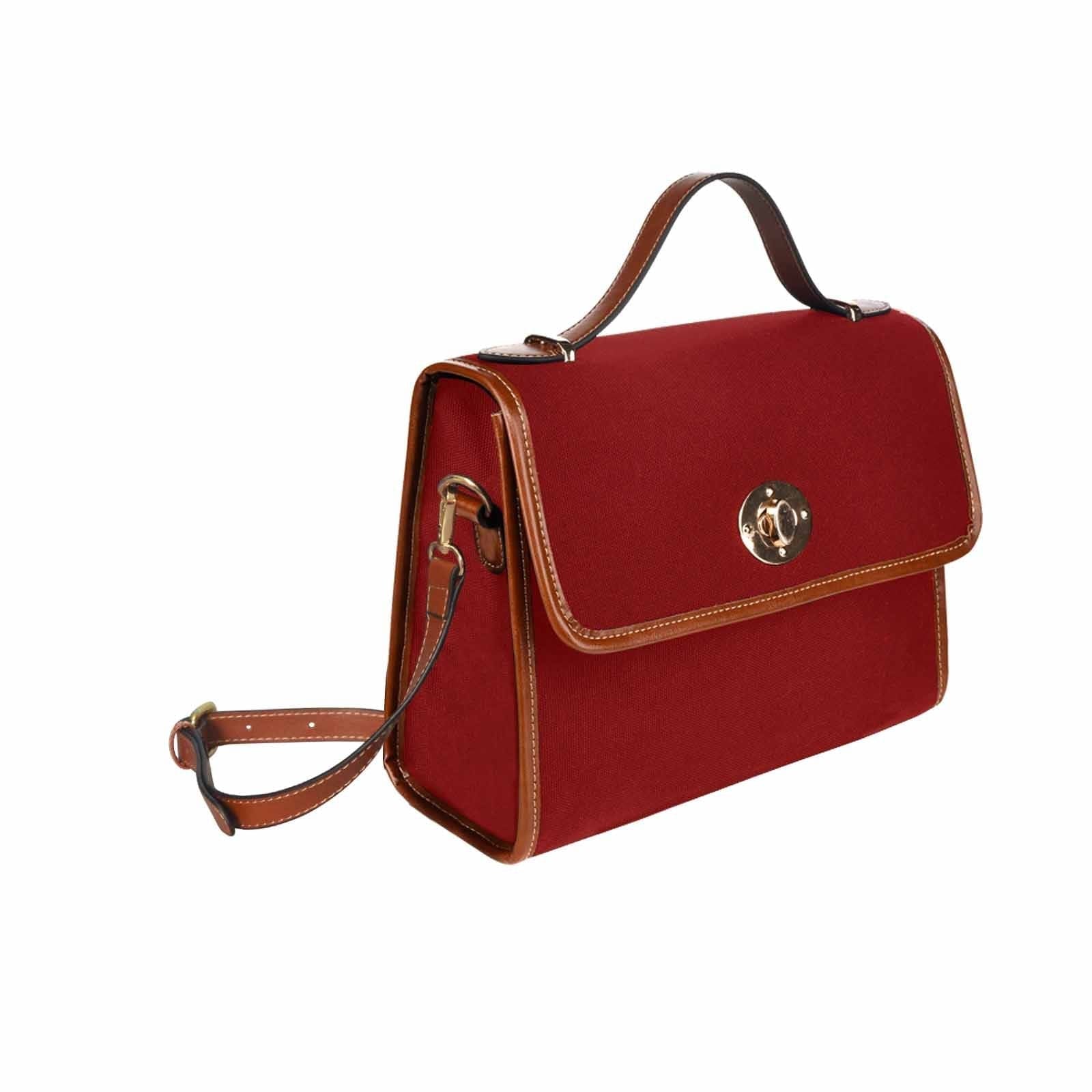 Maroon red waterproof canvas handbag with brown crossbody strap, showcasing its stylish design and functional features.