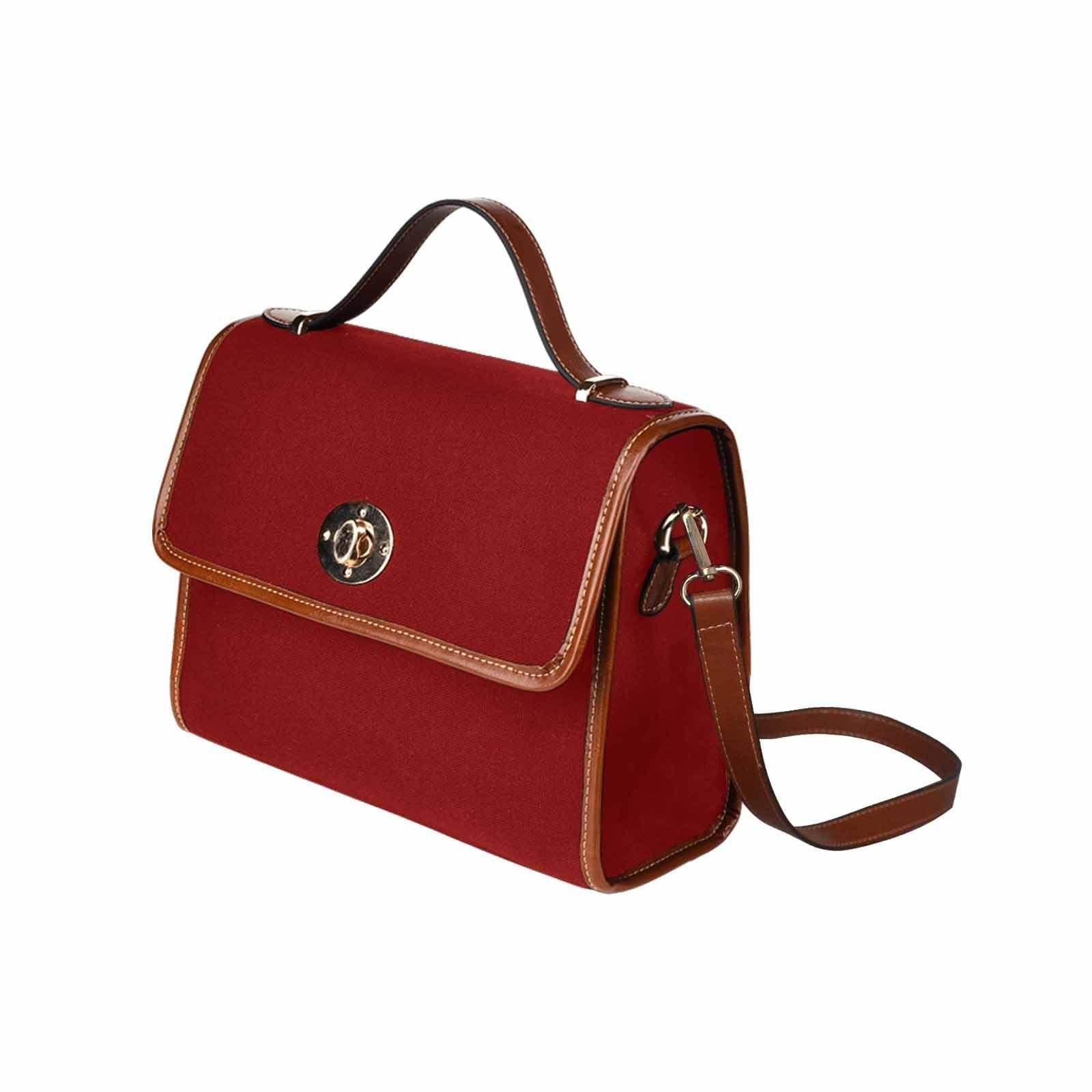 Maroon red waterproof canvas handbag with brown crossbody strap, showcasing its stylish design and functional features.