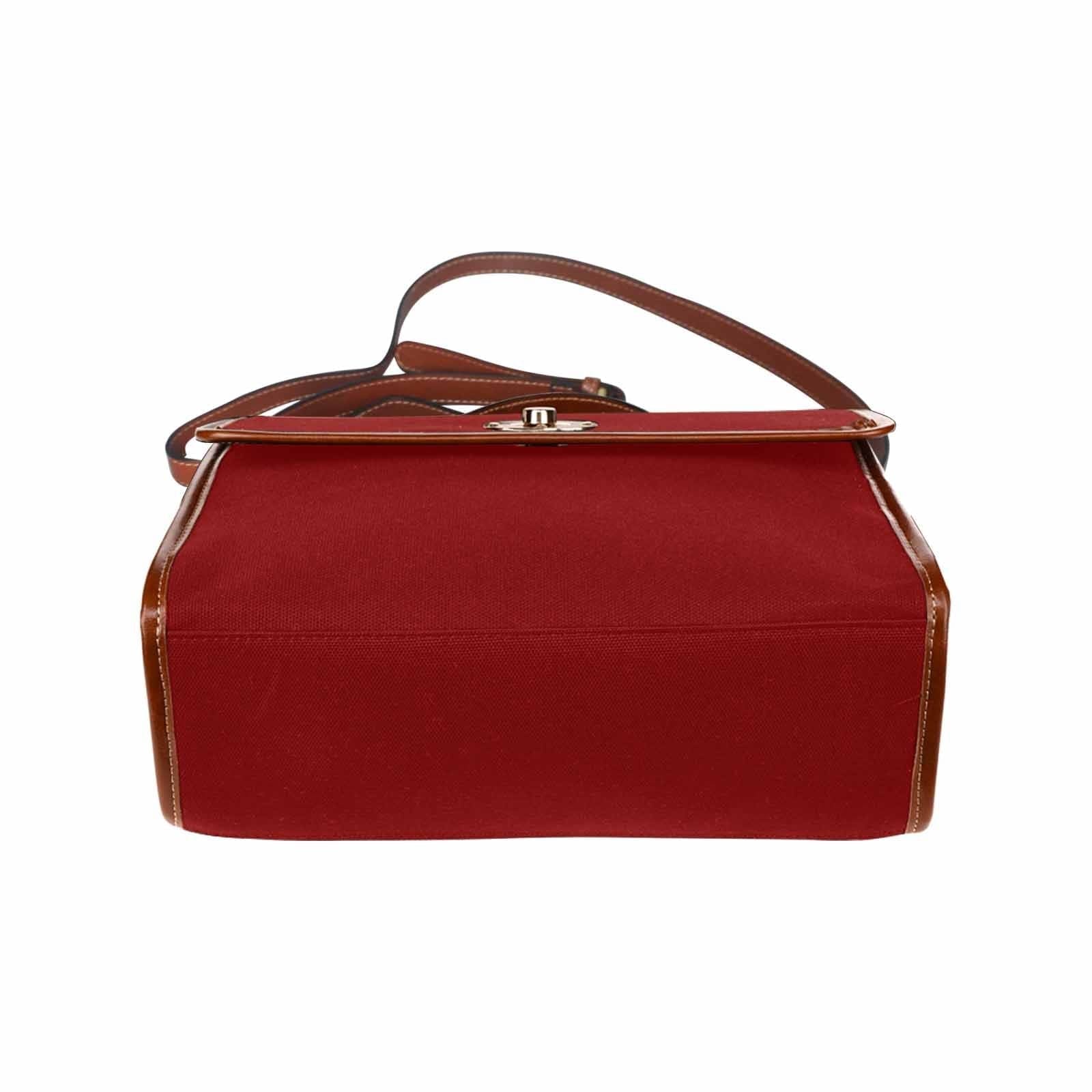 Maroon red waterproof canvas handbag with brown crossbody strap, showcasing its stylish design and functional features.
