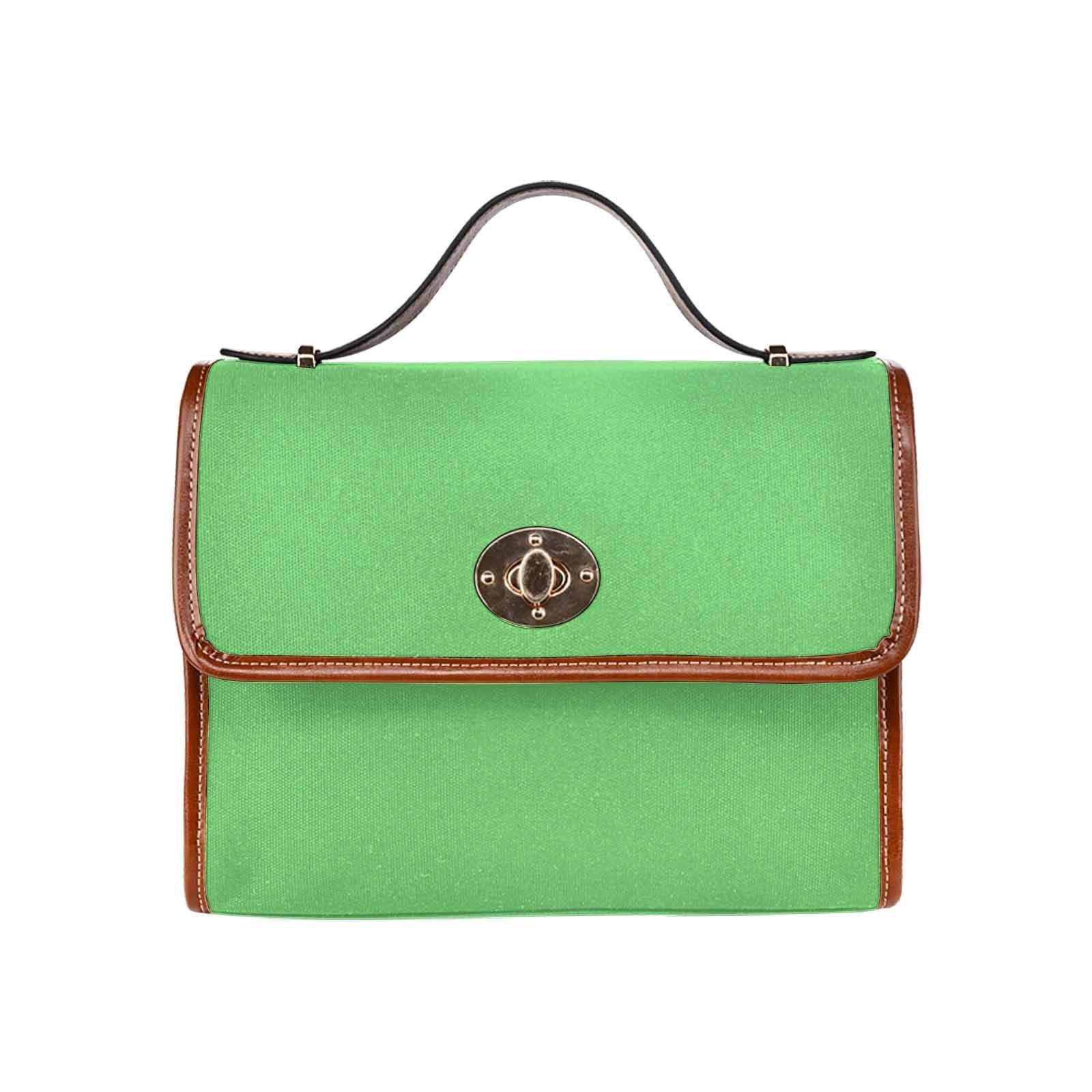 Pastel green waterproof canvas handbag with brown crossbody strap, featuring two interior pockets and a stylish design.