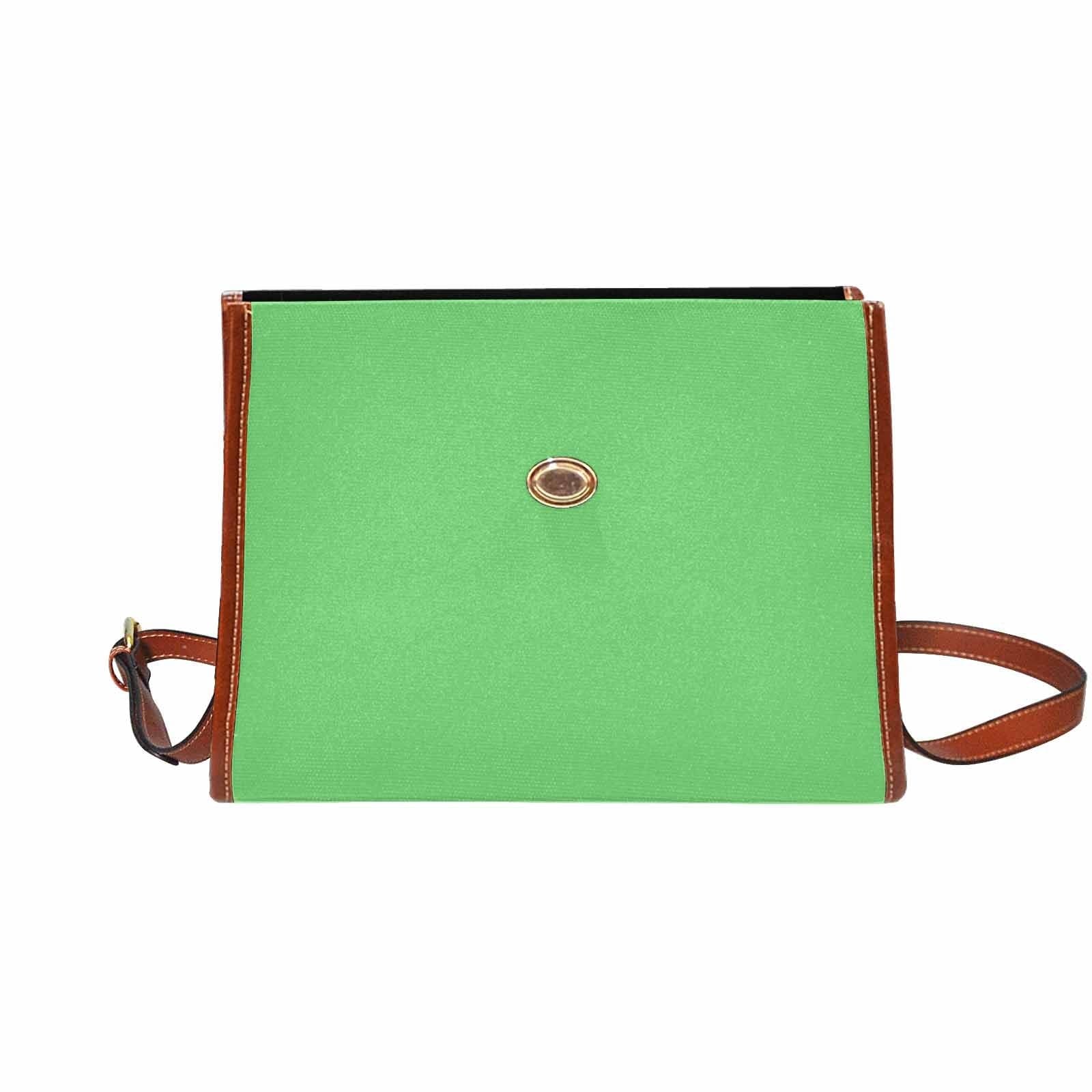 Pastel green waterproof canvas handbag with brown crossbody strap, featuring two interior pockets and a stylish design.