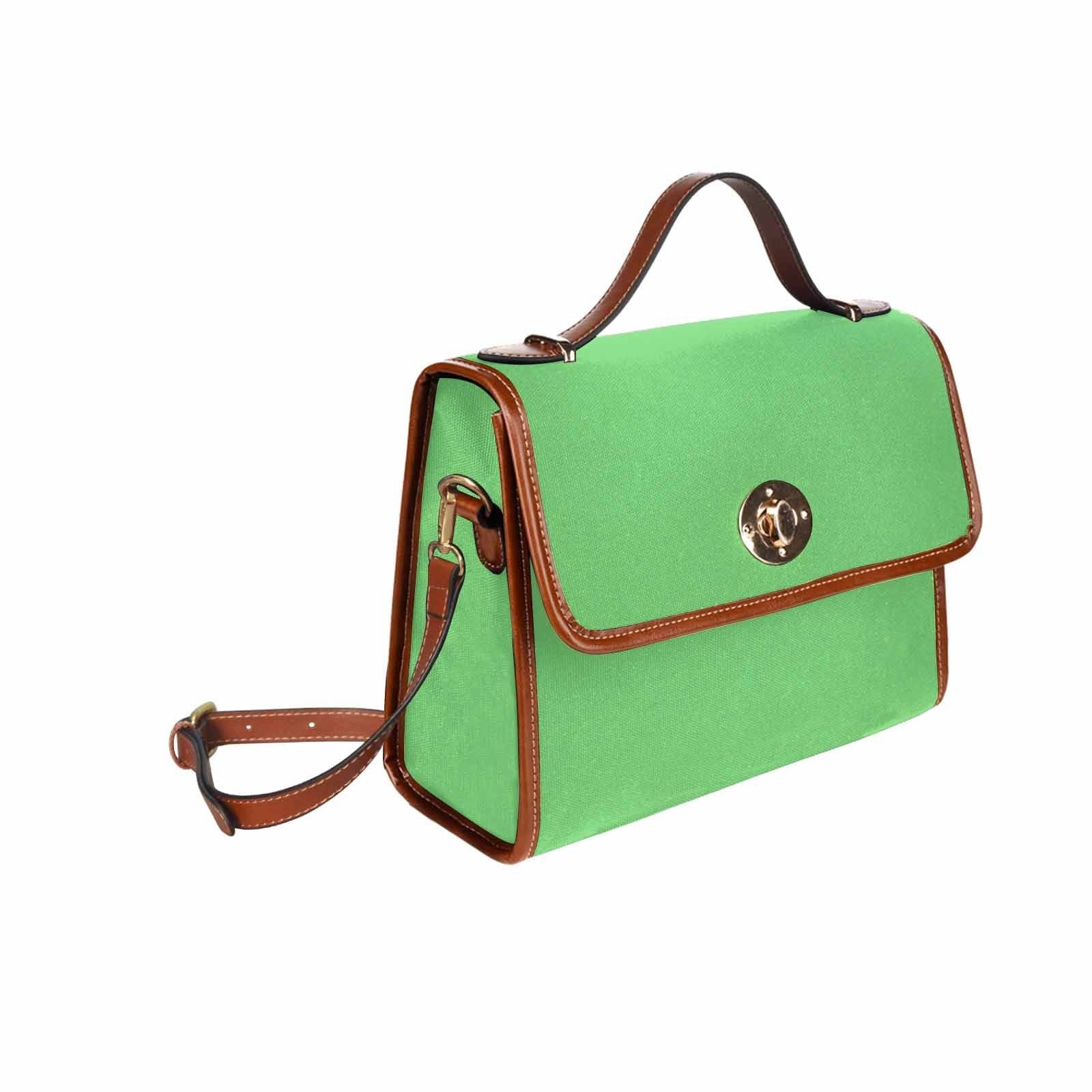 Pastel green waterproof canvas handbag with brown crossbody strap, featuring two interior pockets and a stylish design.