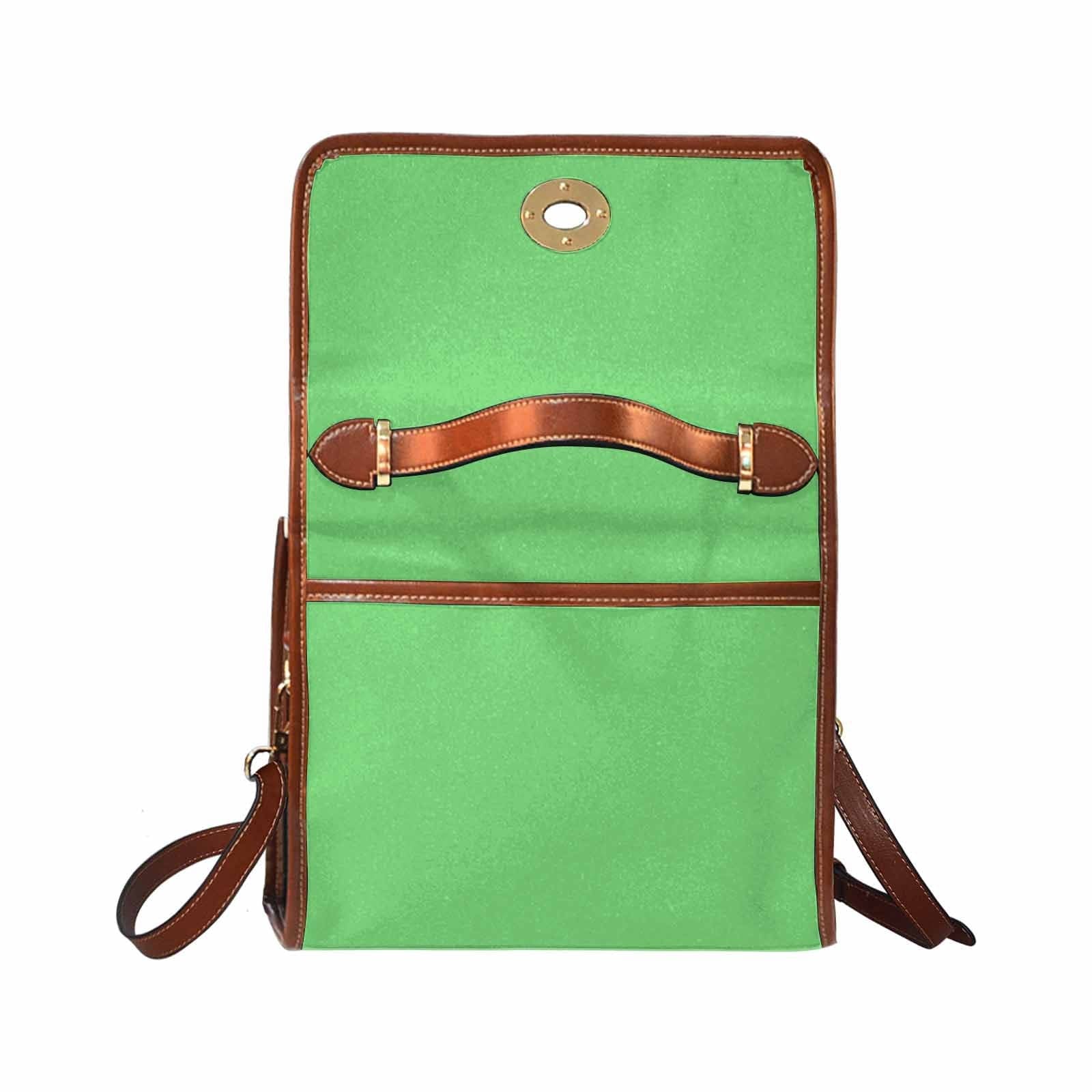 Pastel green waterproof canvas handbag with brown crossbody strap, featuring two interior pockets and a stylish design.