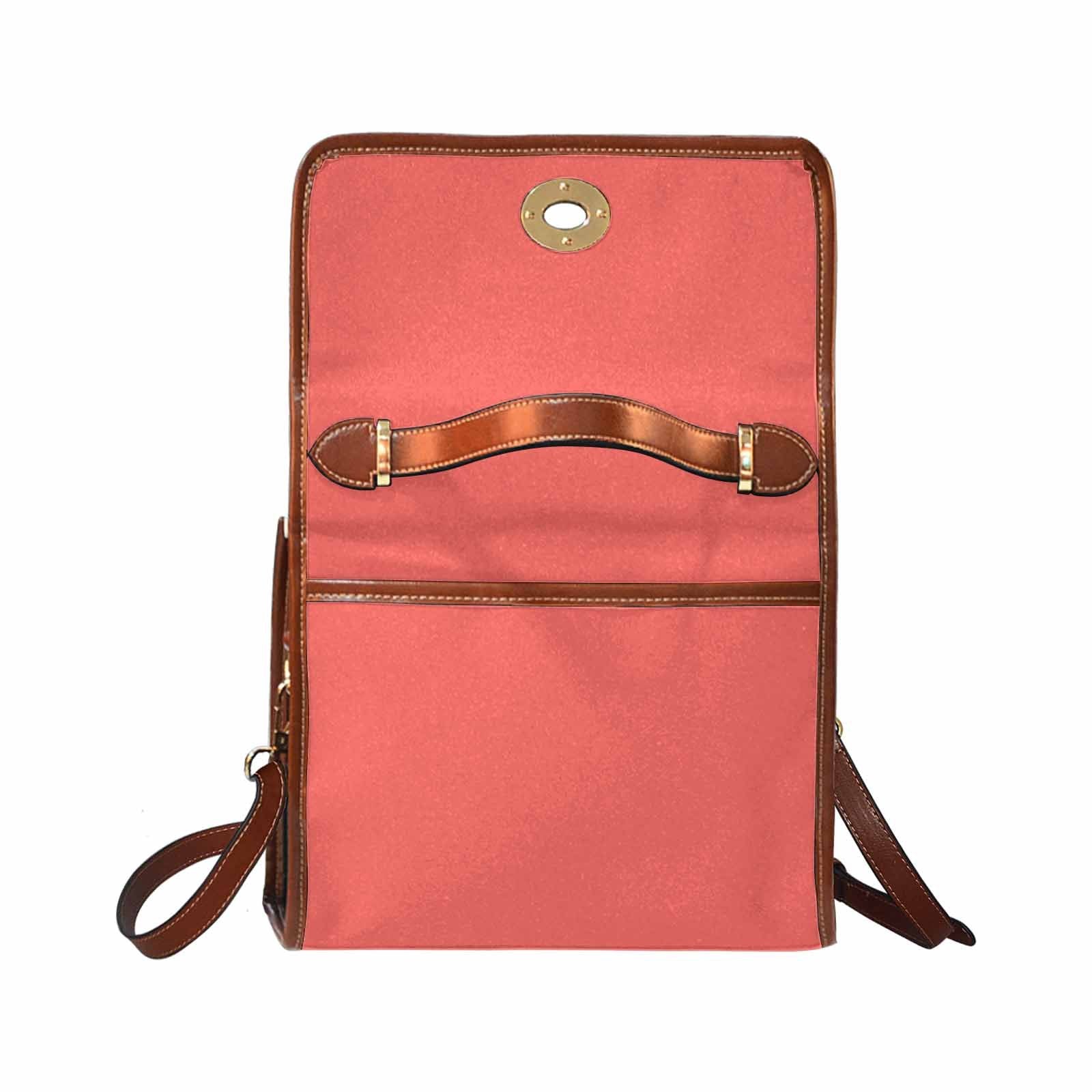 Pastel red waterproof canvas handbag with brown crossbody strap, featuring two interior pockets and a zipper pocket.