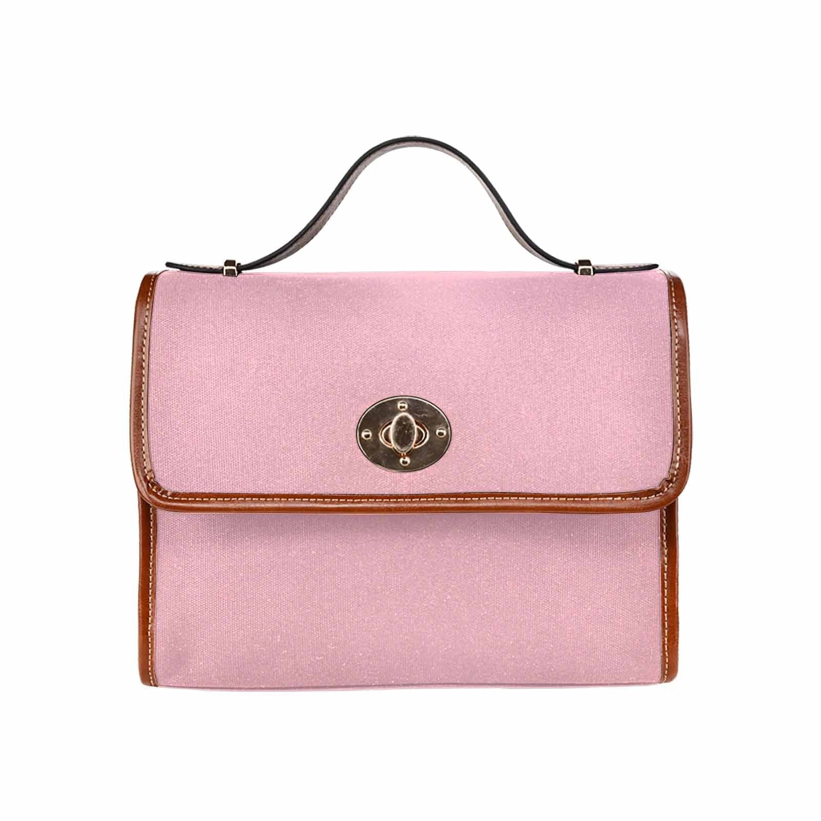 Stylish pink waterproof canvas handbag with brown crossbody strap, featuring two interior pockets and a zipper pocket.