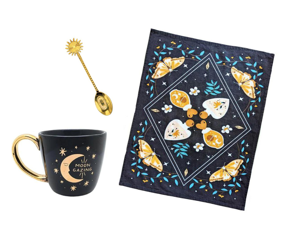 Celestial Tea Set featuring a mystical tea towel, a ceramic mug with gold designs, and a brass sun spoon, perfect for herbal tea rituals.