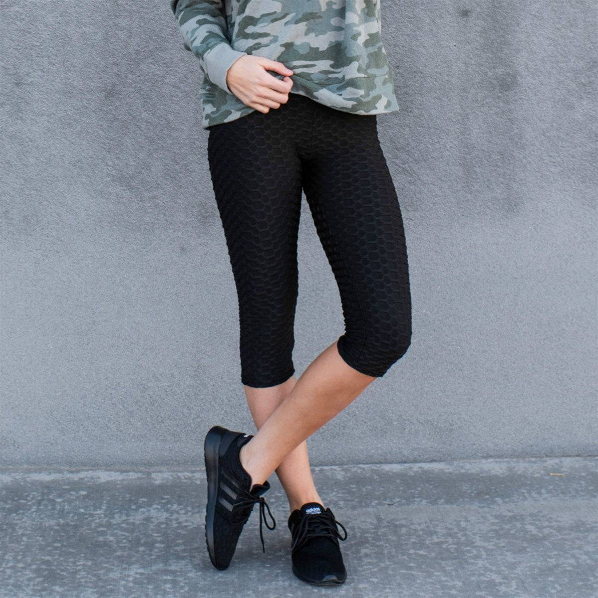 A pair of stylish Cellulite Hiding Capri Leggings in textured fabric, designed to enhance curves and provide comfort.