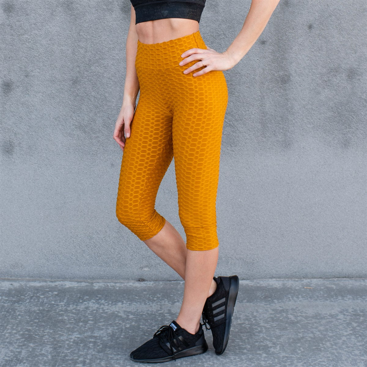 A pair of stylish Cellulite Hiding Capri Leggings in textured fabric, designed to enhance curves and provide comfort.