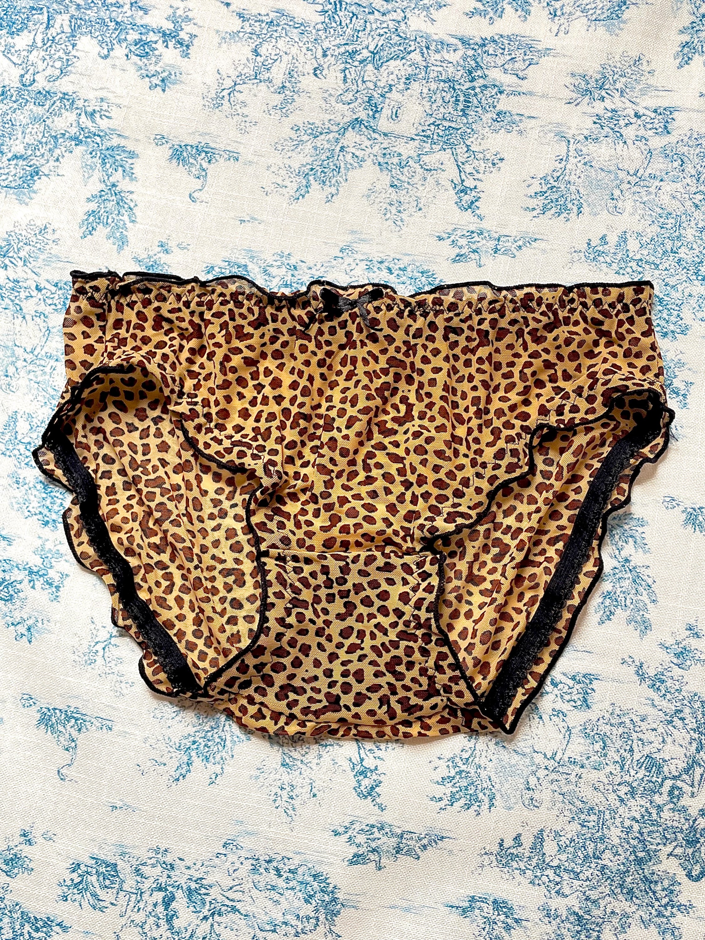 Cheetah Print Panty featuring black lettuce trim and bow detail, made with 100% cotton lining for comfort.