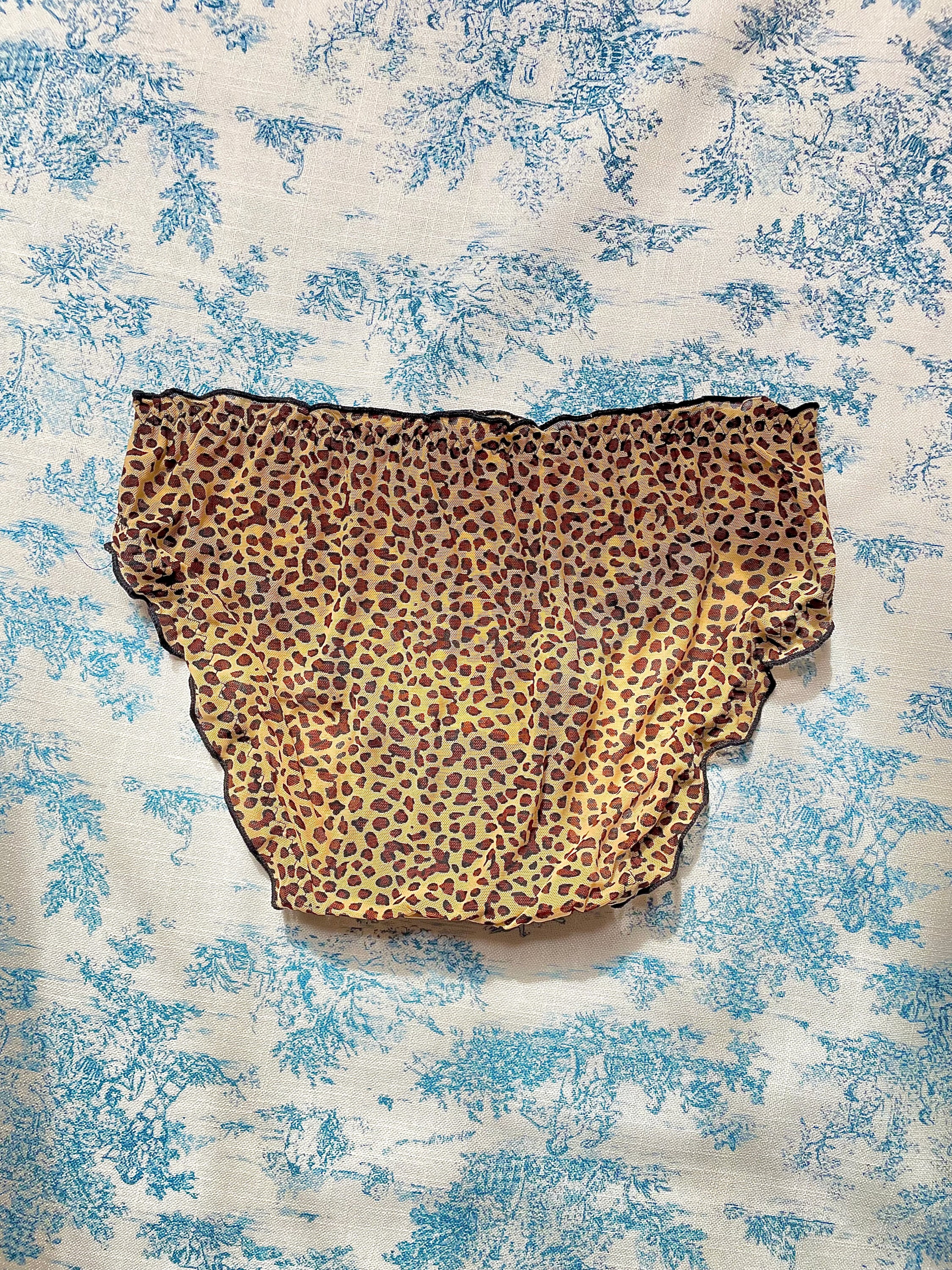 Cheetah Print Panty featuring black lettuce trim and bow detail, made with 100% cotton lining for comfort.