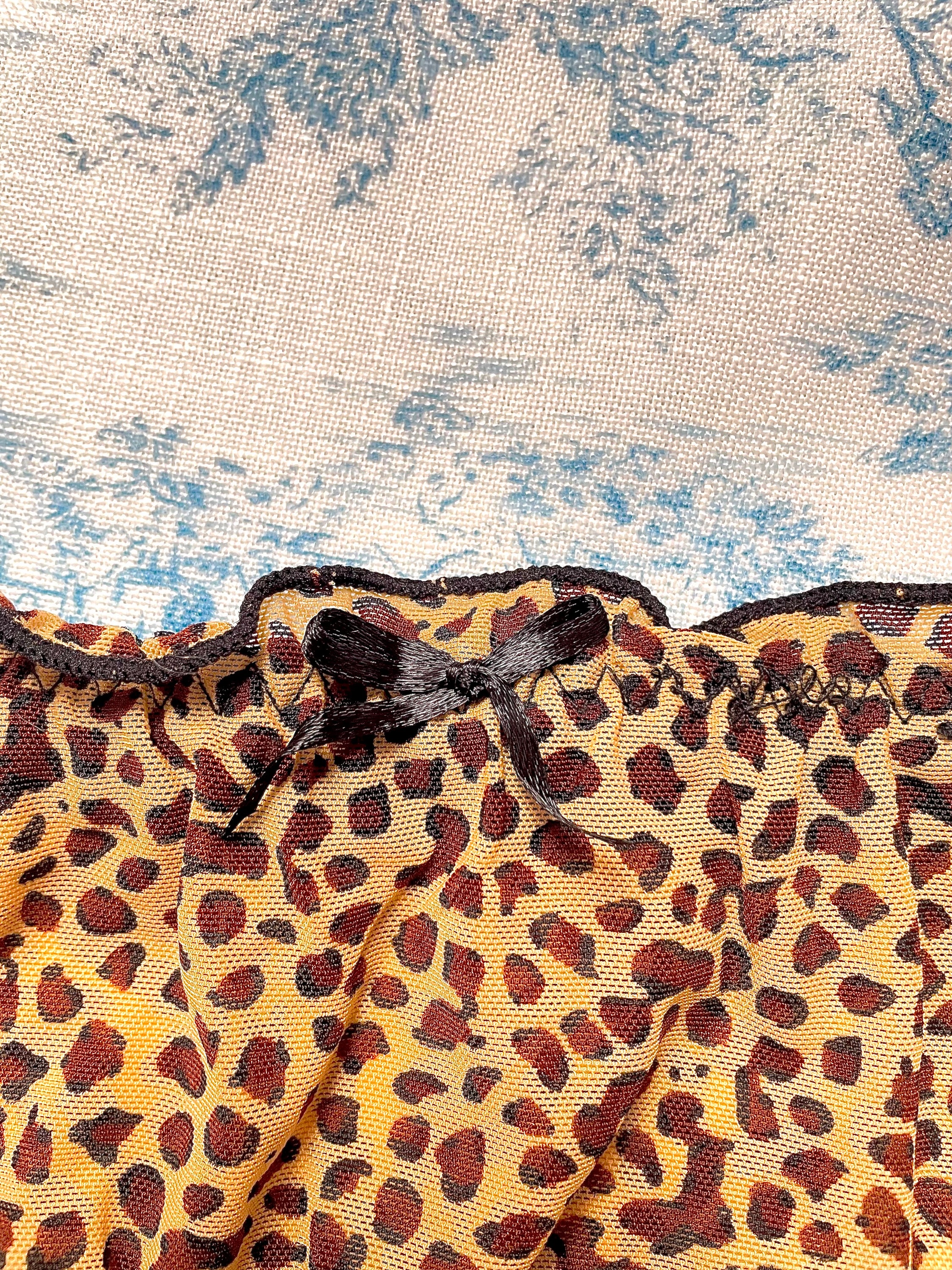 Cheetah Print Panty featuring black lettuce trim and bow detail, made with 100% cotton lining for comfort.