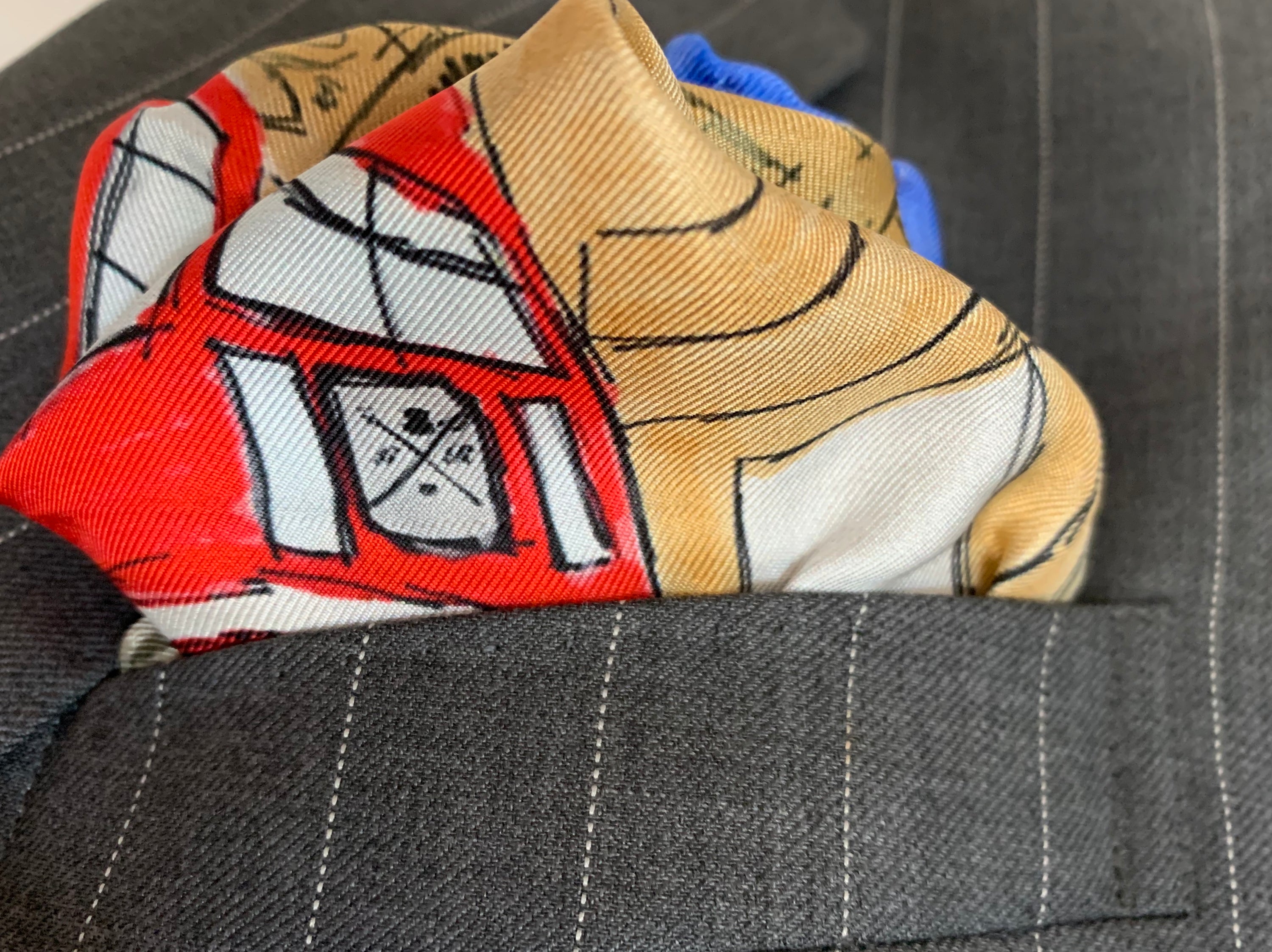 Classic London Pocket Square featuring hand-sketched London landmarks in blue and red silk.