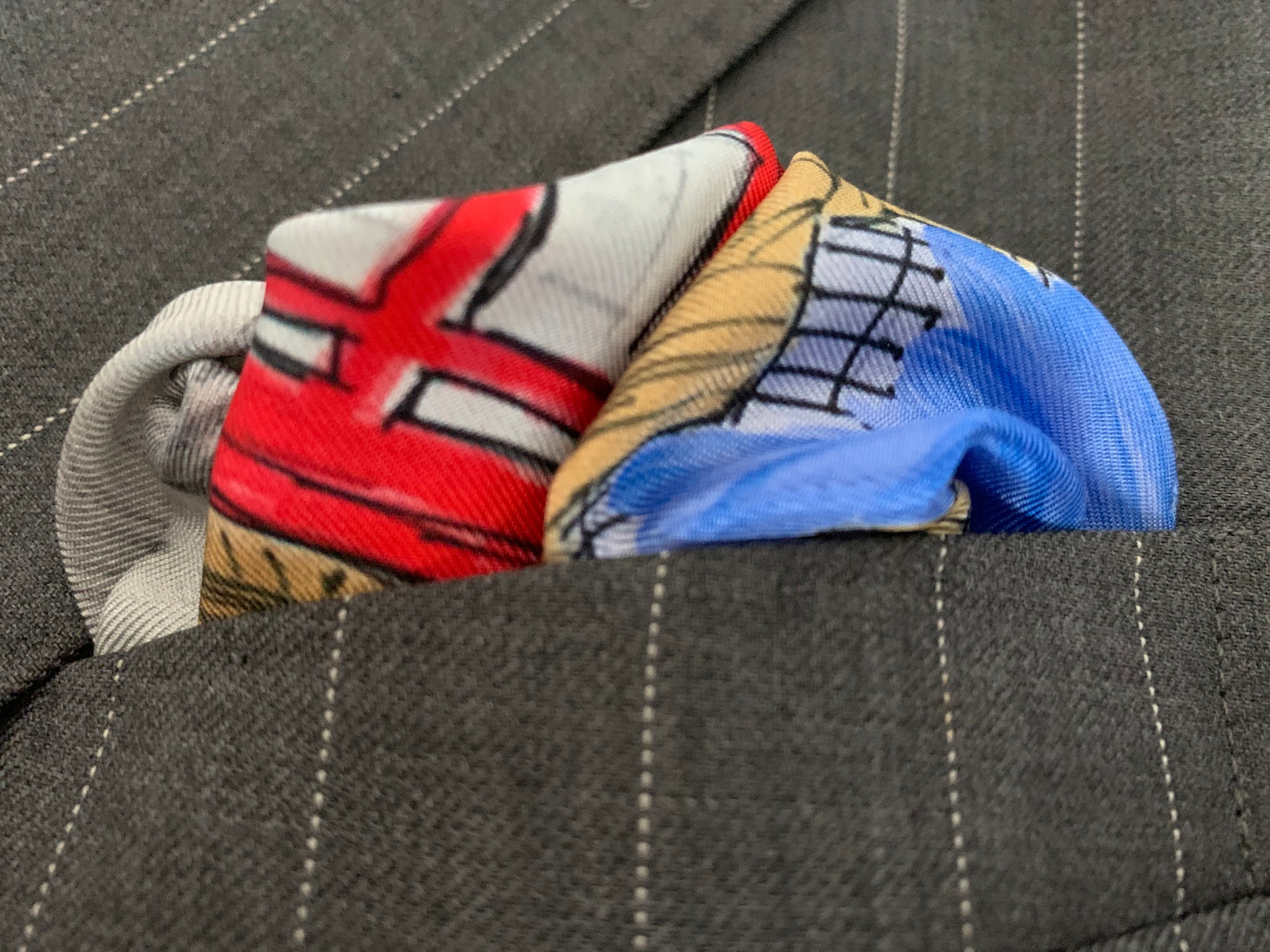 Classic London Pocket Square featuring hand-sketched London landmarks in blue and red silk.