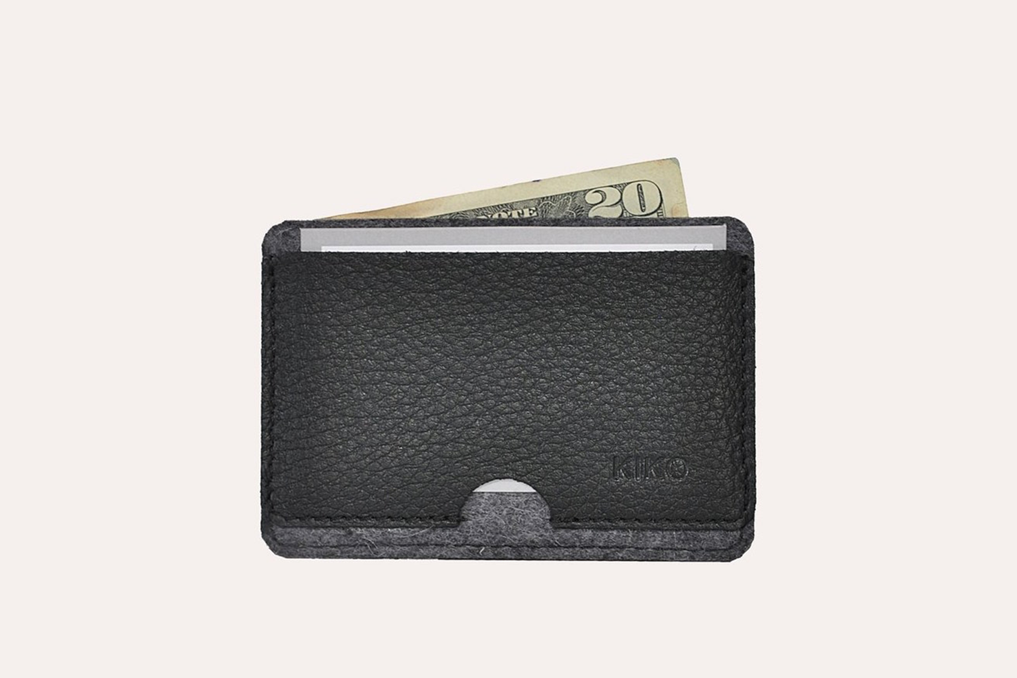 A stylish Combo Card Case made from wool felt and vegetable tanned cowhide leather, featuring rustic heat burnished details and two slots for cards and cash.