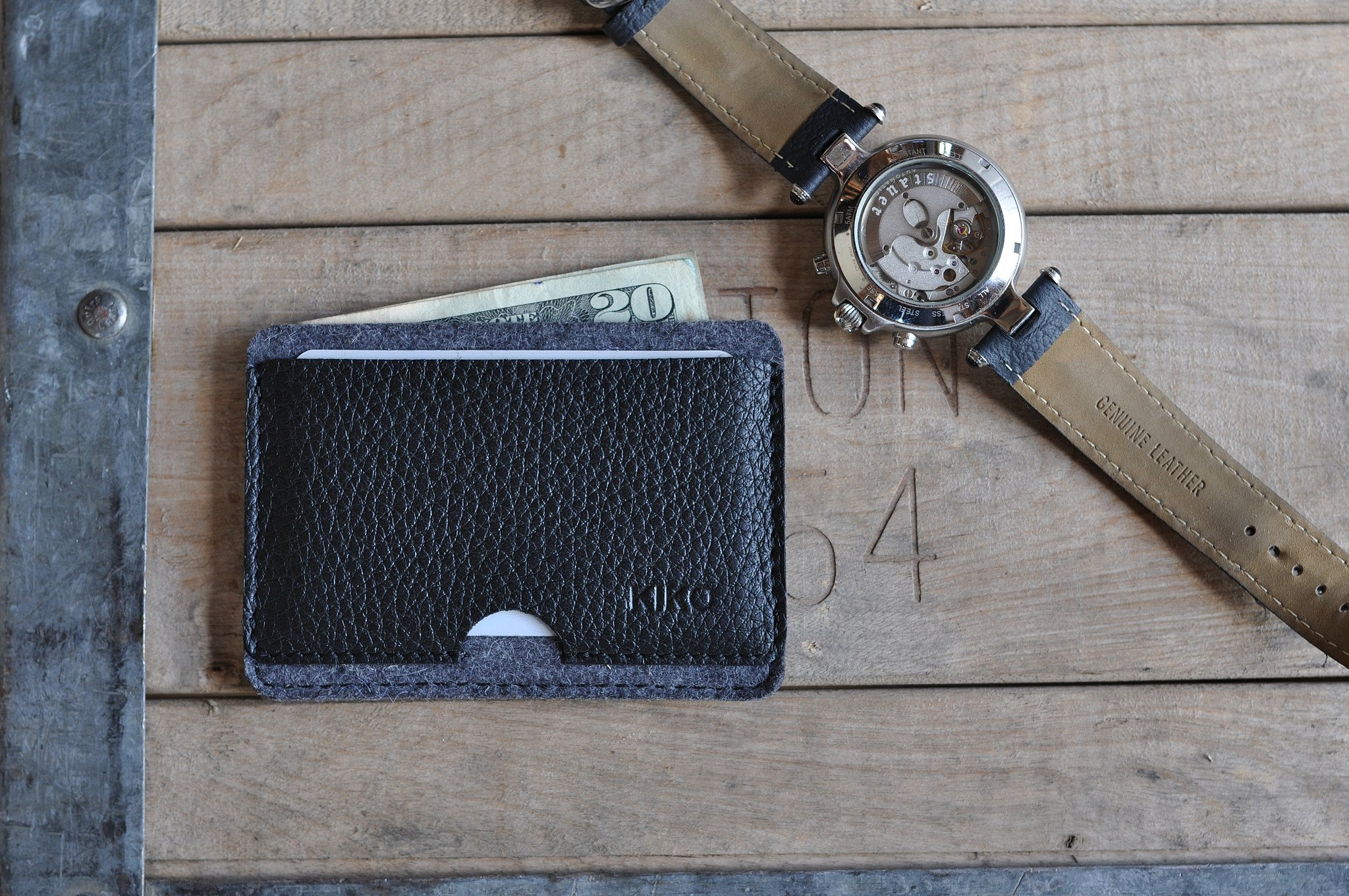 A stylish Combo Card Case made from wool felt and vegetable tanned cowhide leather, featuring rustic heat burnished details and two slots for cards and cash.