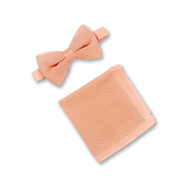 Coral fusion knitted bow tie and matching pocket square set displayed elegantly, showcasing vibrant color and texture.