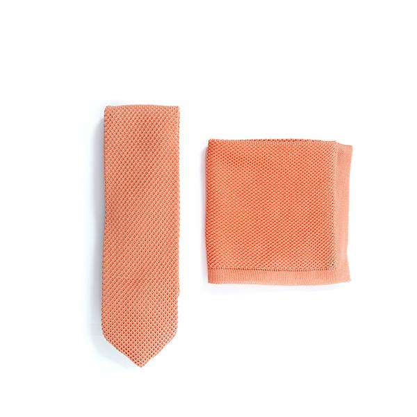 Coral fusion knitted tie and pocket square set displayed elegantly, showcasing vibrant color and texture.