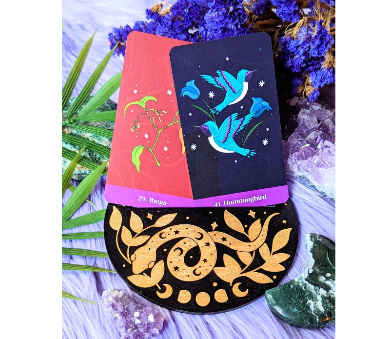 Cosmic Serpent Oracle Card Holder displaying a tarot card, featuring intricate serpent designs.
