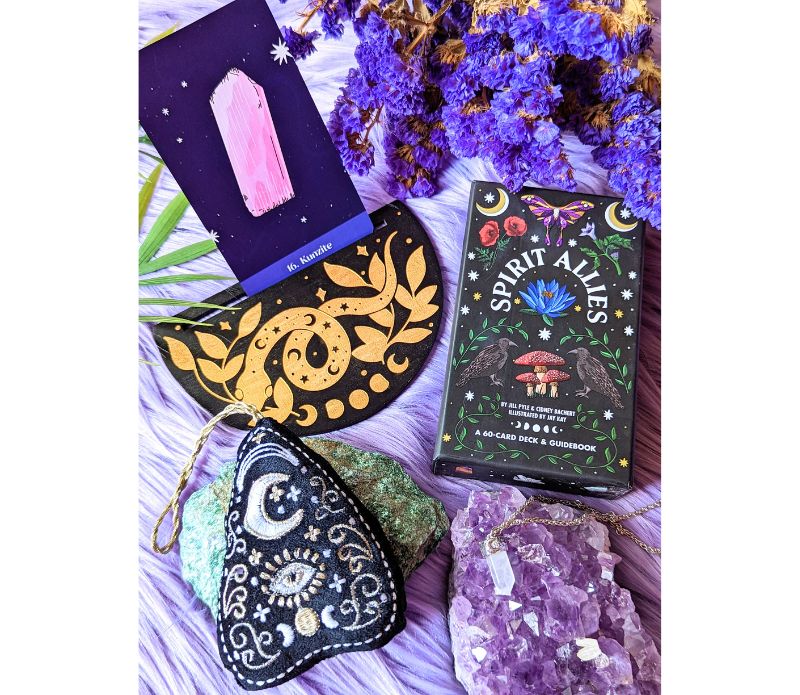 Cosmic Serpent Oracle Card Holder displaying a tarot card, featuring intricate serpent designs.