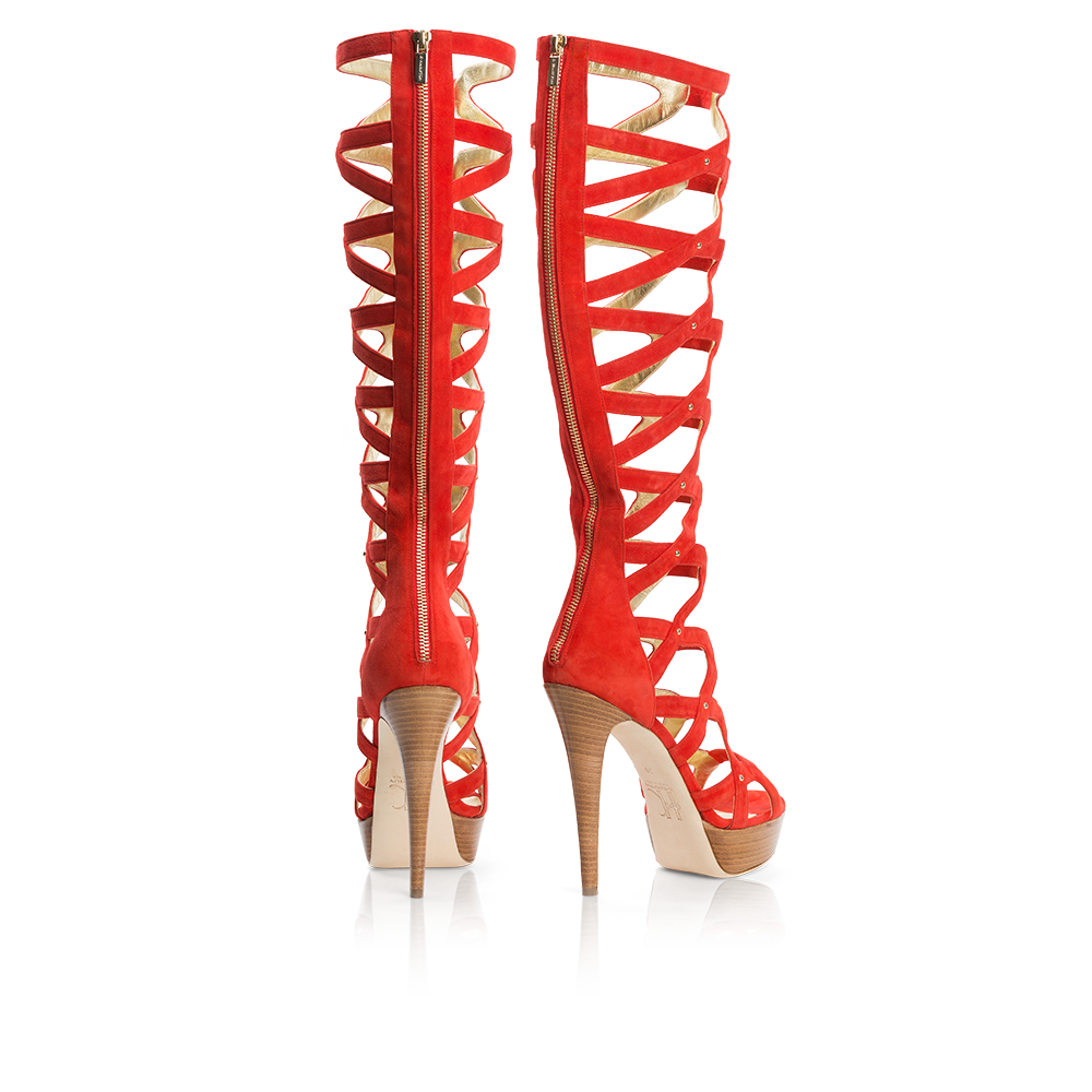 Courage stiletto featuring crimson suede, stud details, and a gold zipper, set on a wood veneer platform.