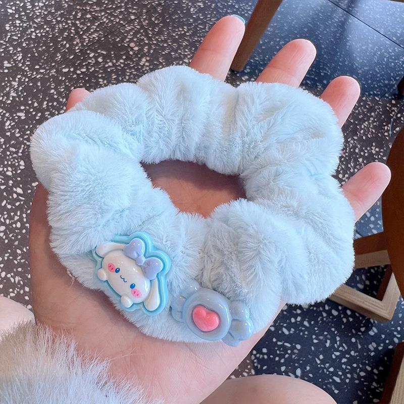 A set of four cute fluffy scrunchies with big ears, showcasing their soft texture and vibrant colors, perfect for stylish hairstyles.