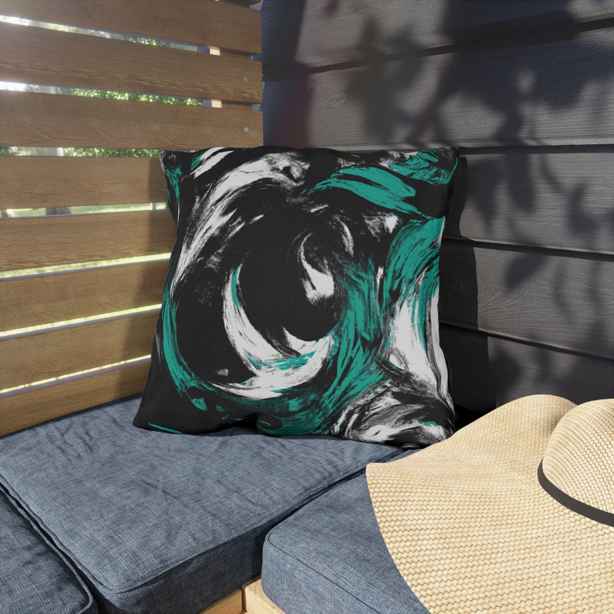 Decorative indoor/outdoor pillow featuring a black, green, and white abstract pattern, ideal for enhancing outdoor decor.