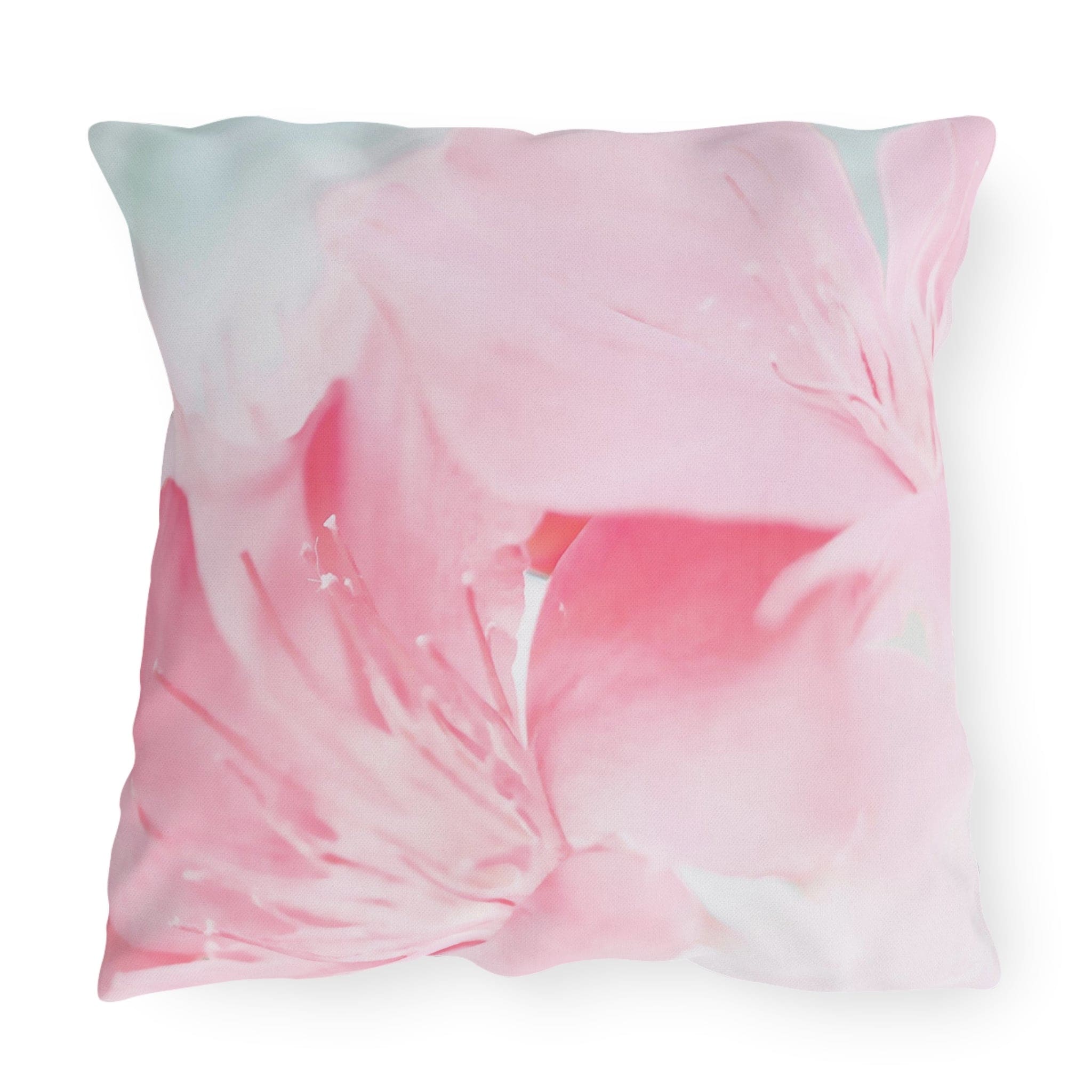 Decorative indoor/outdoor pillow with a vibrant pink flower bloom design, showcasing its double-sided print and soft texture.