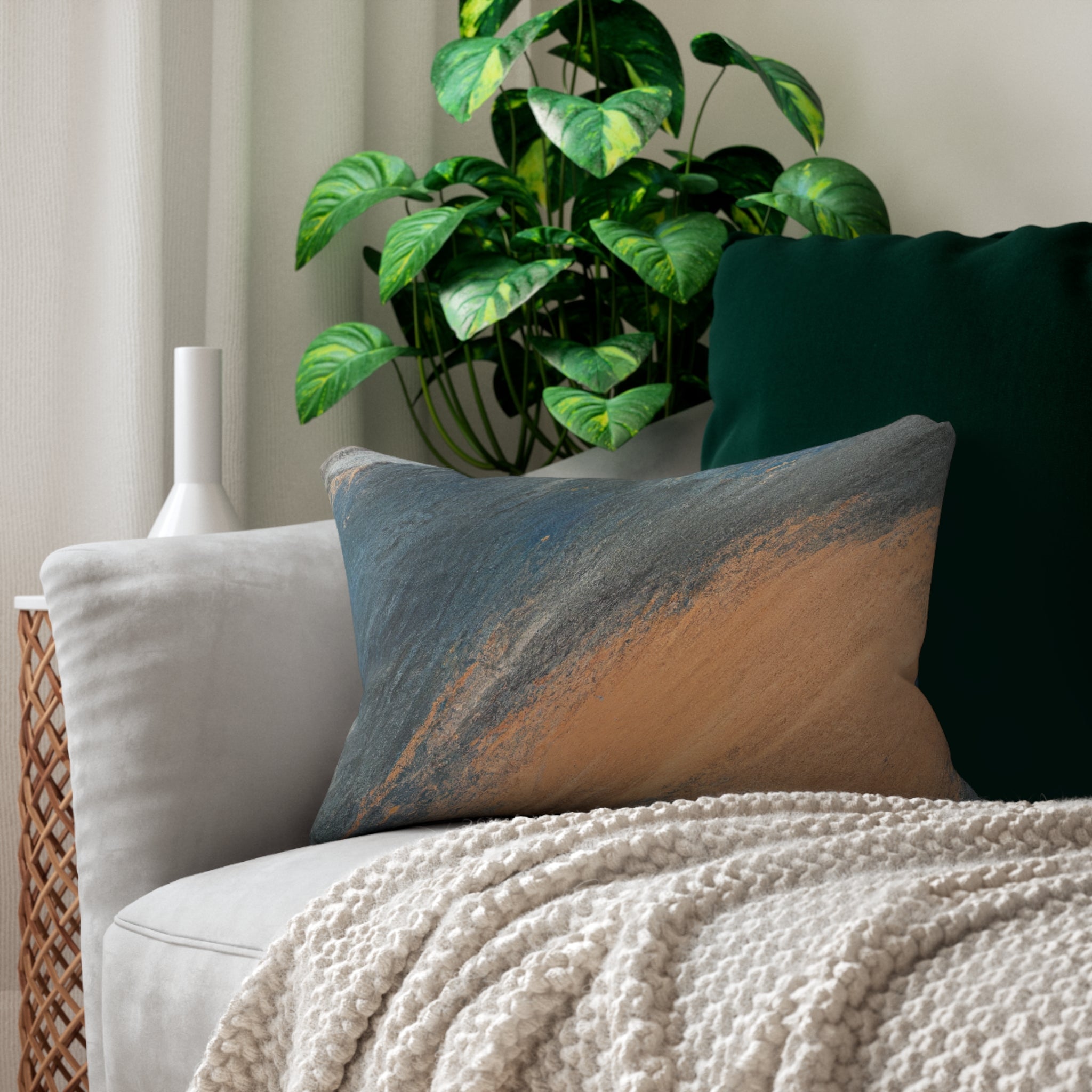 Decorative lumbar throw pillow featuring an abstract pattern in blue, orange, and grey, showcasing vibrant colors and artistic design.