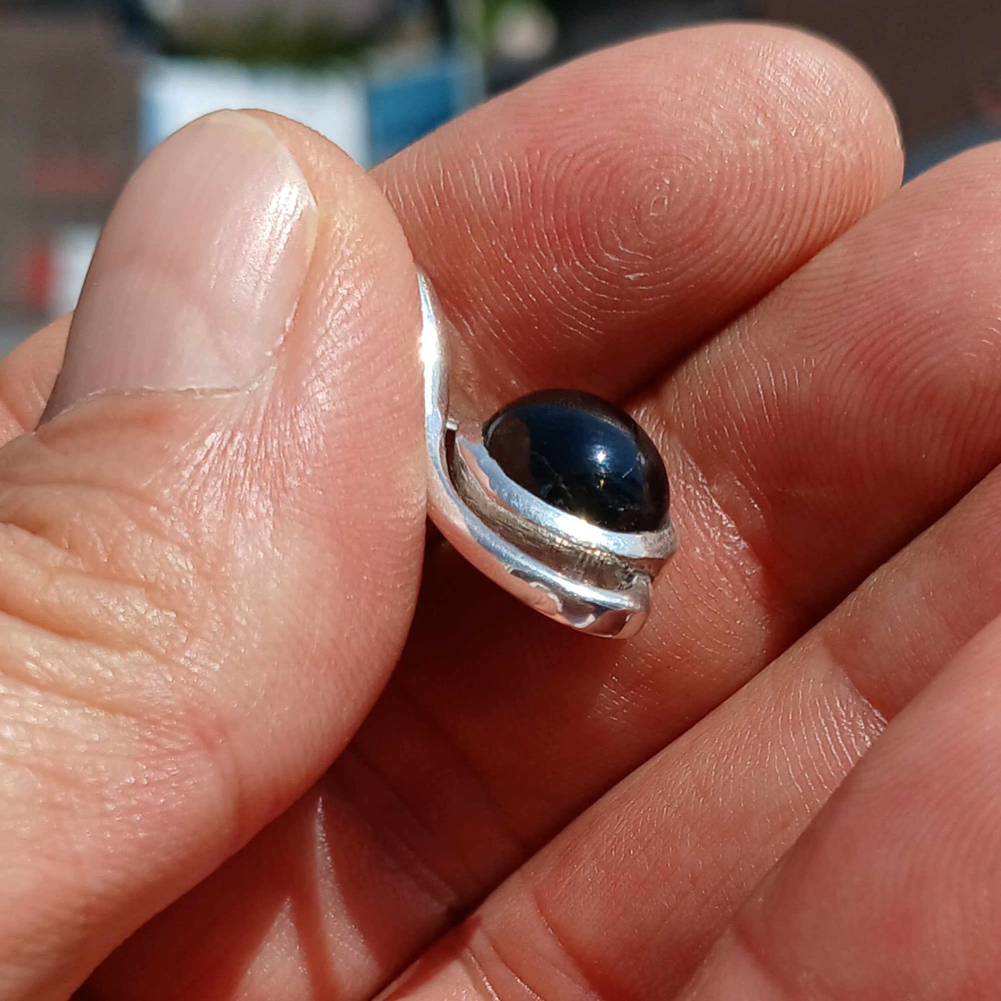 A stunning Black Star Diopside pendant in sterling silver, showcasing a unique 4-ray star pattern, elegantly crafted and hallmarked 925.