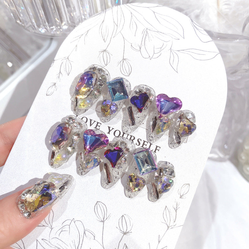 A beautifully arranged 24-piece set of sparkling gem fake nails, showcasing various designs and colors, perfect for bridal nail art.