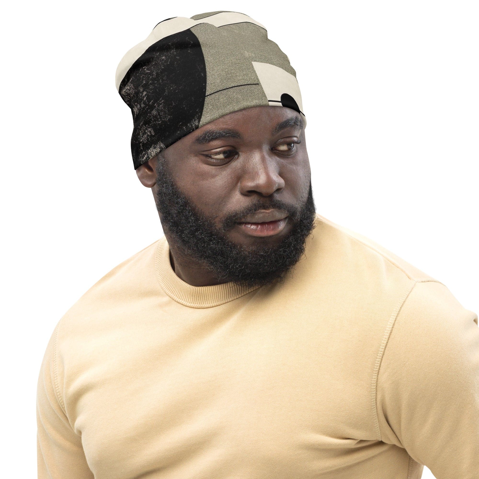 Double-layered beanie hat featuring abstract black, beige, and brown geometric shapes, perfect for stylish warmth.