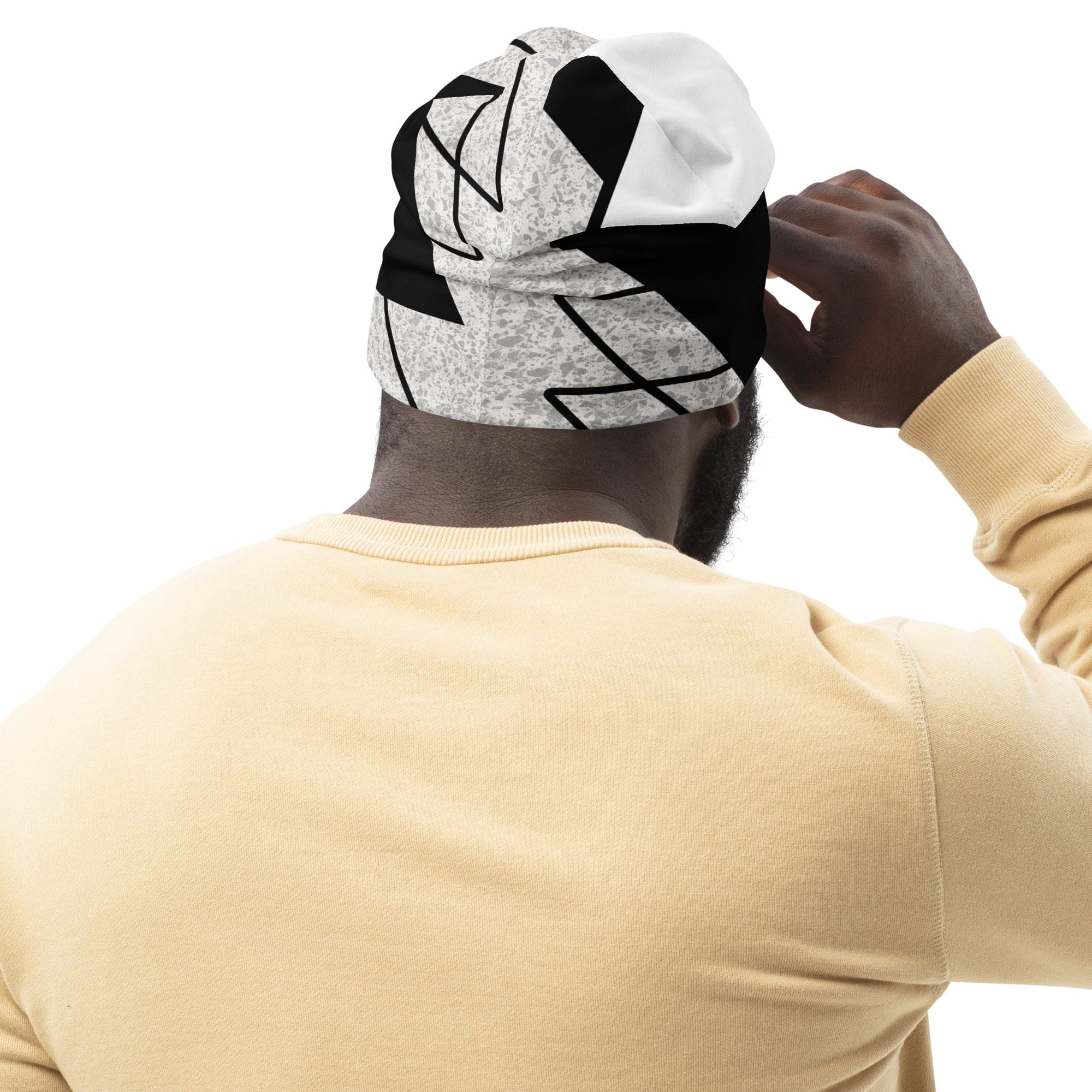 Double-layered beanie hat in black and white ash grey triangular colorblock design, showcasing its soft fabric and stylish appearance.