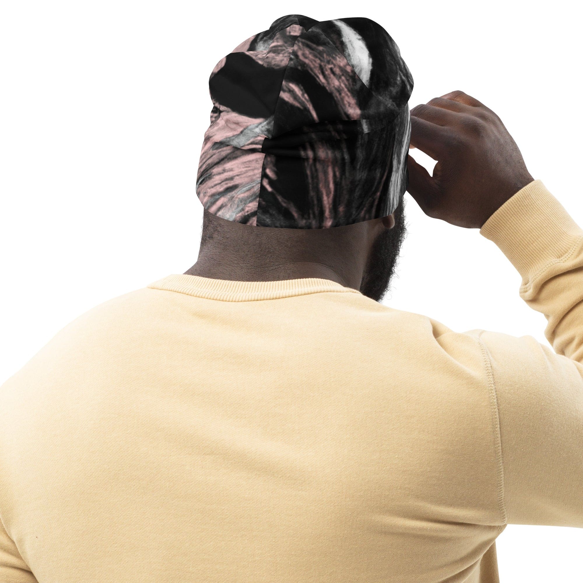 Double-layered beanie hat in black, pink, and white abstract pattern, showcasing its stylish design and soft fabric.