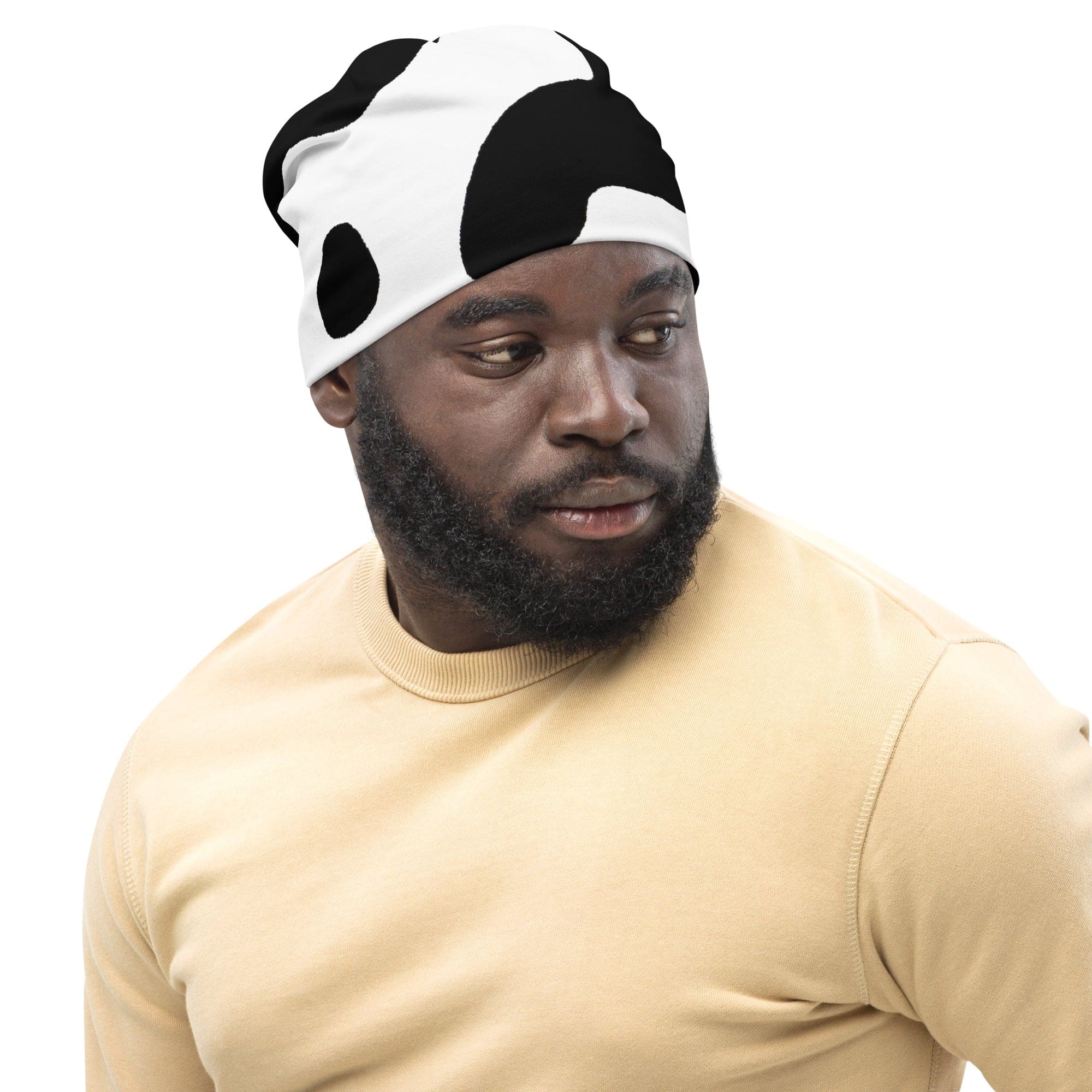 Double-layered beanie hat featuring a stylish black and white cow print design, perfect for winter and all seasons.