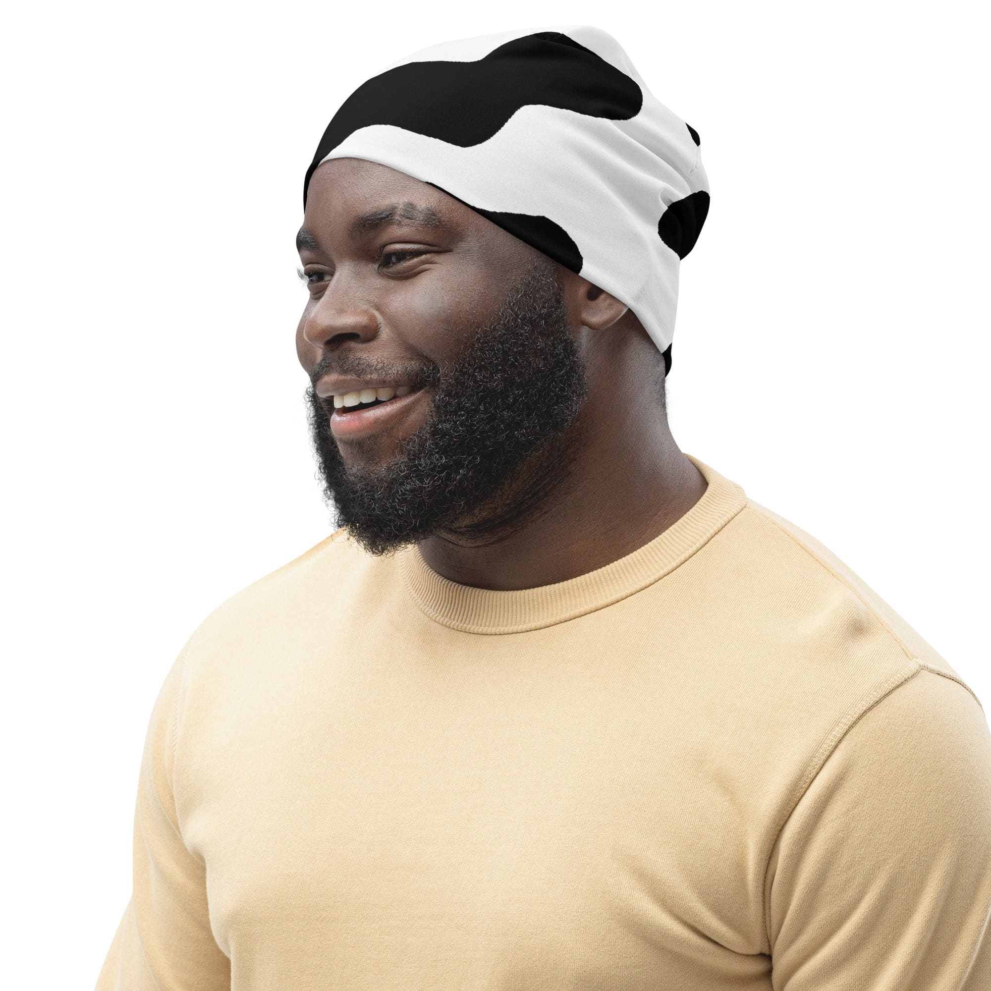 Double-layered beanie hat featuring a stylish black and white cow print design, perfect for winter and all seasons.