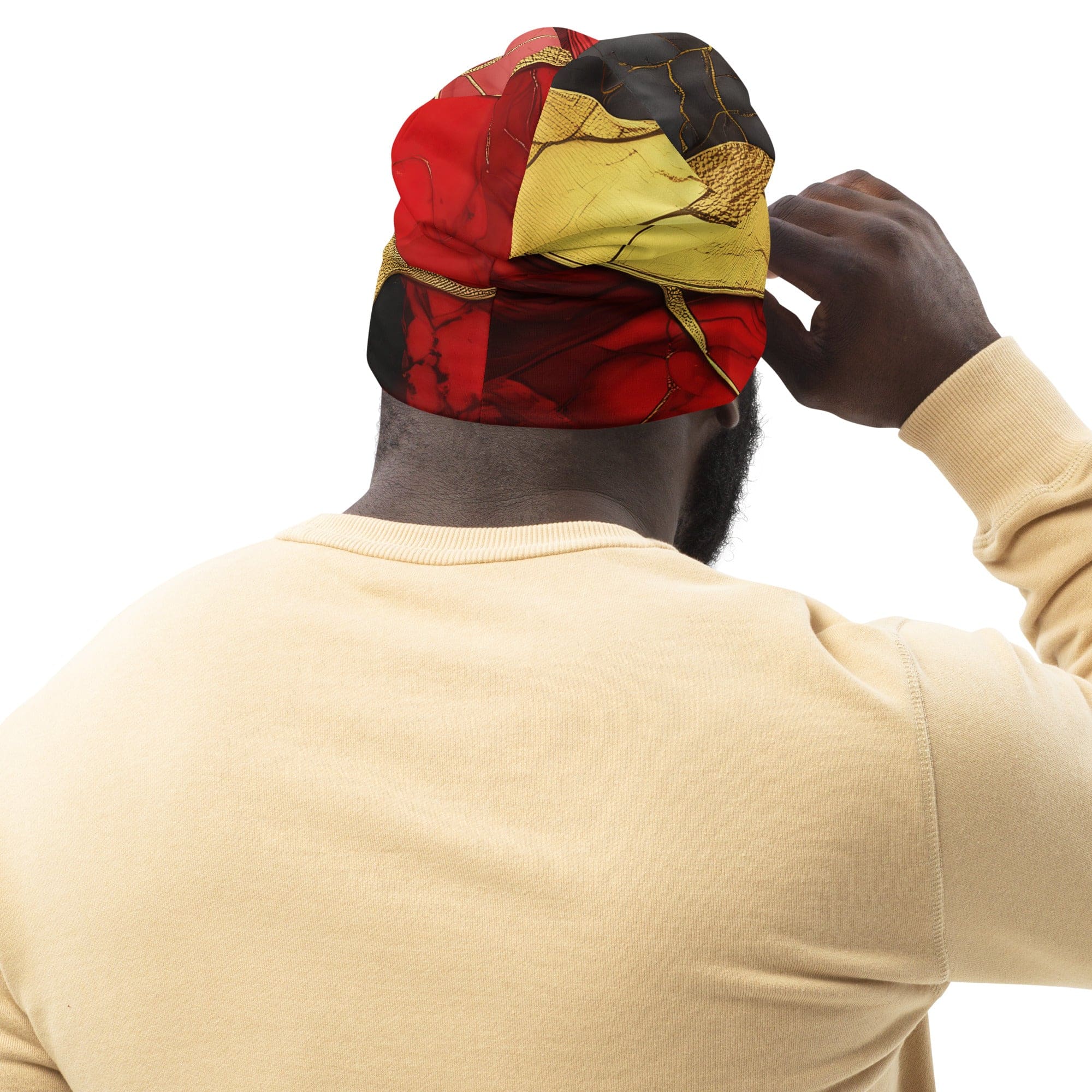 A vibrant double-layered beanie hat featuring bold red and gold tones print, perfect for winter and spring wear.