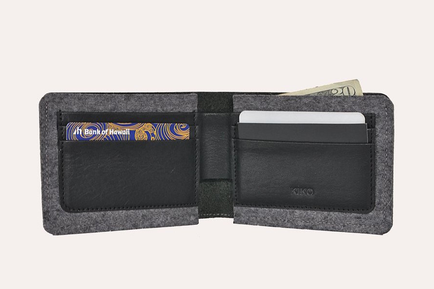 A stylish Dual Textured Wallet made from American Horween leather and wool felt, showcasing its sleek design and card slots.