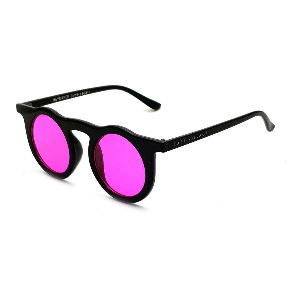 East Village 'Haymaker' Round Sunglasses featuring black frames and pink lenses, stylishly displayed with a branded pouch.