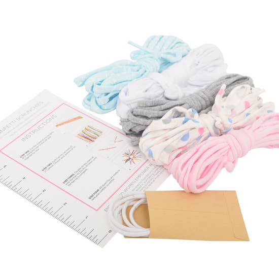 Eco DIY Scrunchie Kit featuring colorful upcycled materials and hair ties for crafting stylish scrunchies.