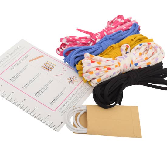 Eco DIY Scrunchie Kit featuring colorful upcycled materials and hair ties for crafting stylish scrunchies.