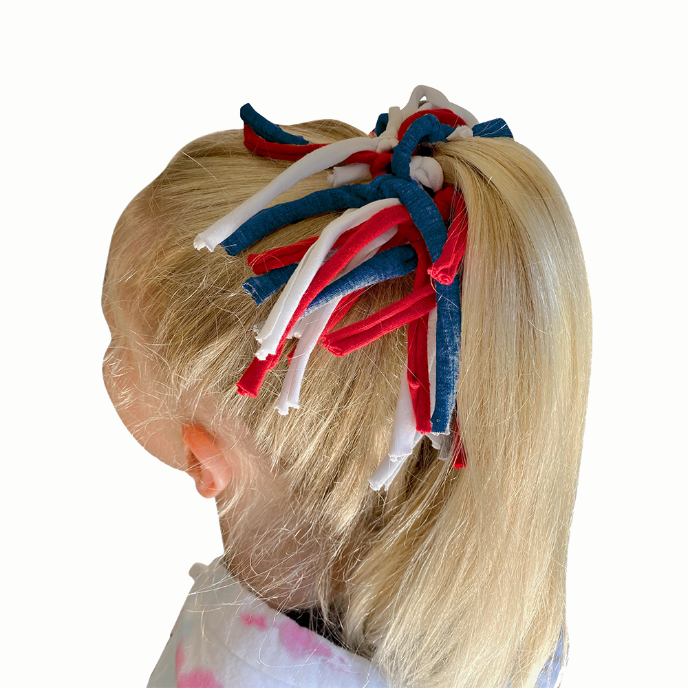 Eco DIY Scrunchie Kit featuring colorful upcycled materials and hair ties for crafting stylish scrunchies.