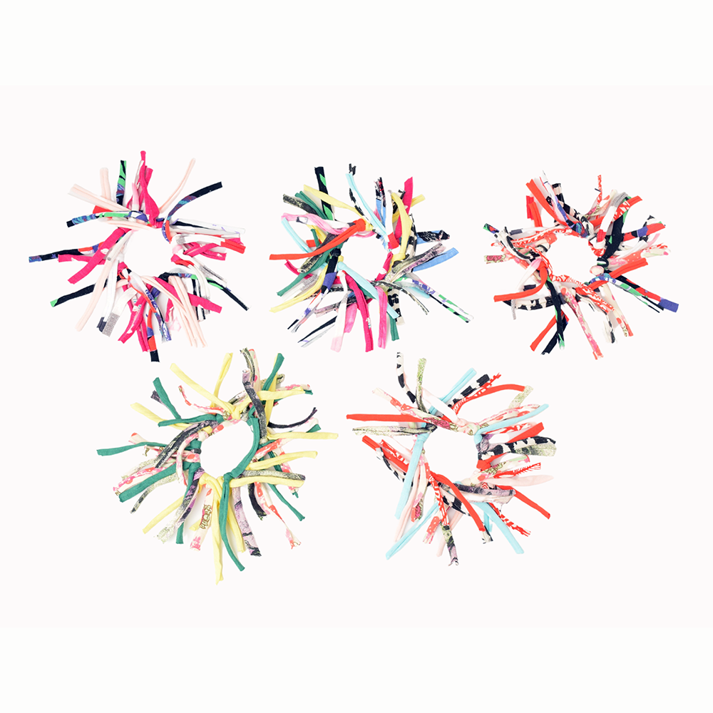 Eco DIY Scrunchie Kit featuring colorful upcycled materials and hair ties for crafting stylish scrunchies.